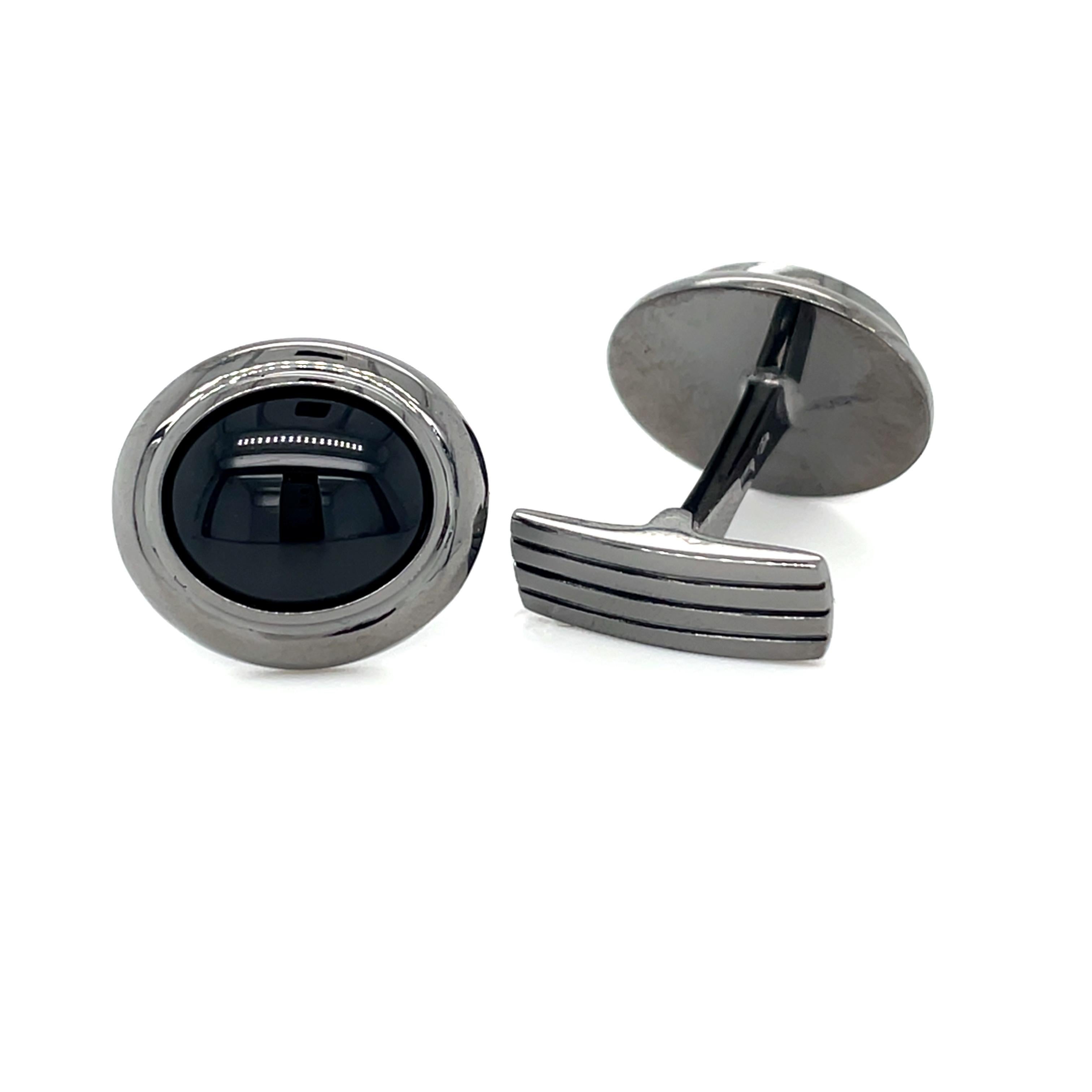 These white gold (black rhodium) cufflinks are from Men's Collection. These cufflinks are decorated with onyx. The total amount of it is 8 Carat. The dimensions of the cufflinks are 1.7cm x 1.5cm. These cufflinks are a perfect upgrade to every