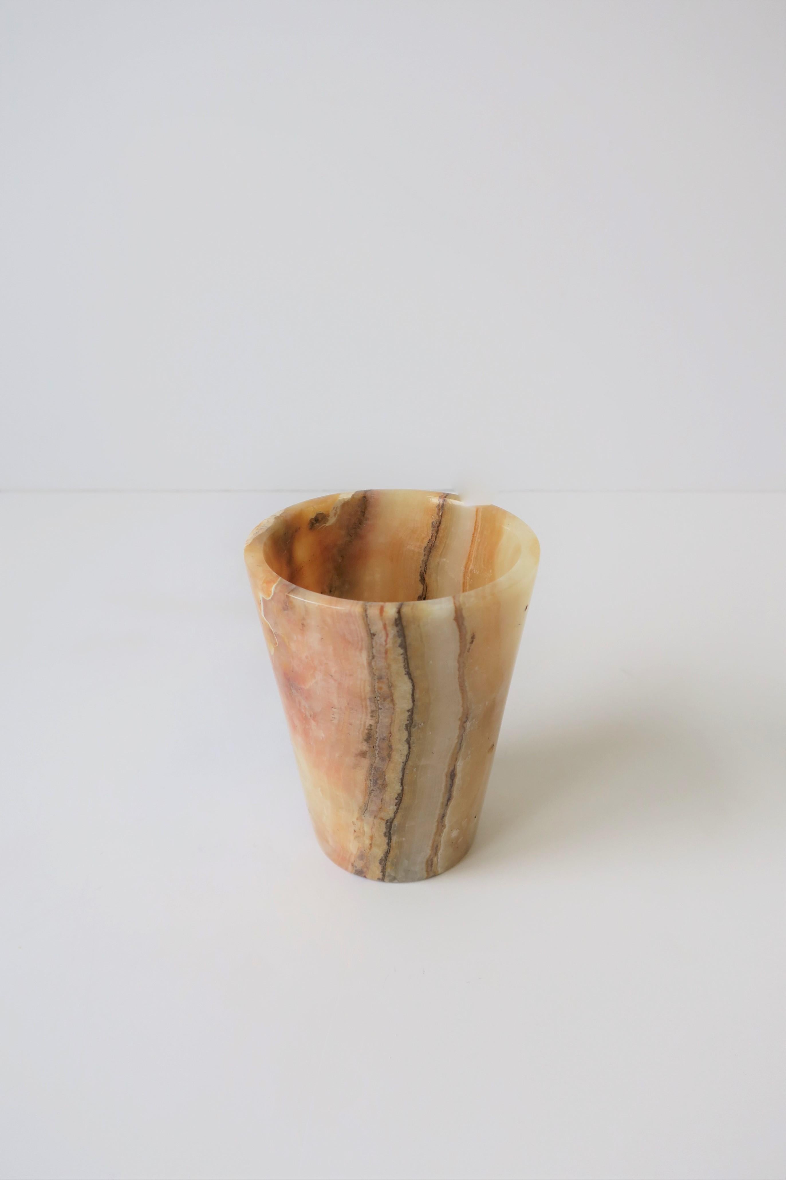 A beautiful onyx marble cup, vase, or vessel. Piece is a bathroom water cup, but can also be used as a small vase or desk vessel (pen/pencil holder.)

Piece measures: 3.25