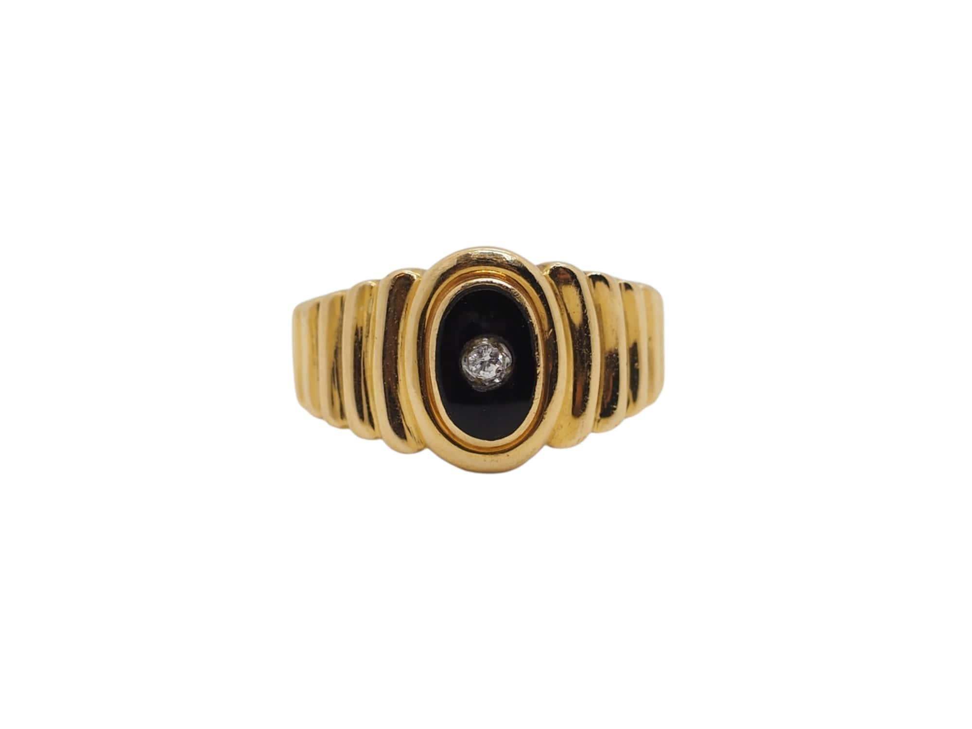 Embrace timeless elegance with our classic stone ring, meticulously crafted in lustrous 18k yellow gold and adorned with a captivating onyx stone and a sparkling diamond totaling approximately 0.03 carats. With a total weight of about 4.7 grams and