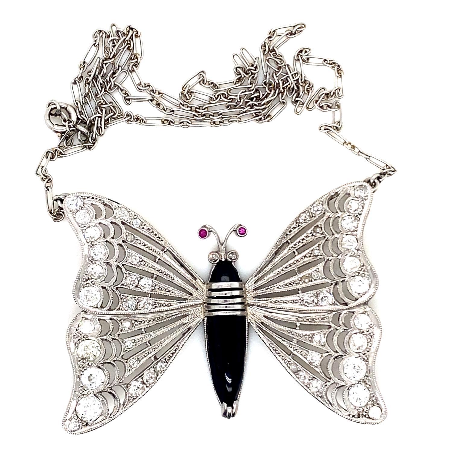 An onyx, diamond and ruby 18 karat white gold butterfly necklace

This fun necklace features two intricately crafted wings grain set in white gold with old cut diamonds of 1.50cts approximately, assessed as H colour, VS2 -SI2 clarity. These are set