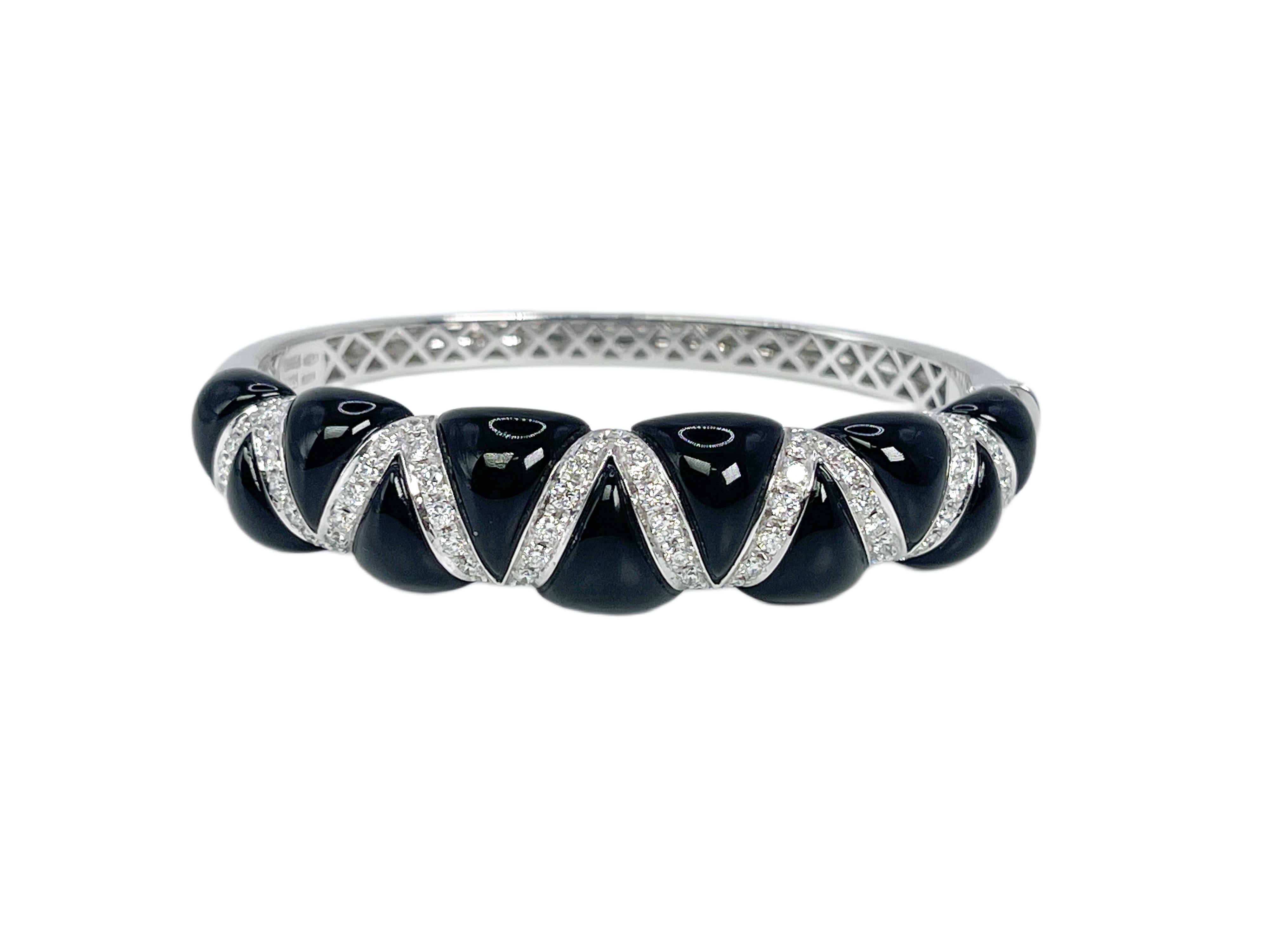 
Important onyx & diamond bangle bracelet made with custom cut onyx pieces and VS diamonds. The piece is finished in 18KT white gold by the designer Chantecler.

GRAM WEIGHT: 40.82gr
GOLD: 18KT white gold

NATURAL DIAMOND(S)
Cut: Round