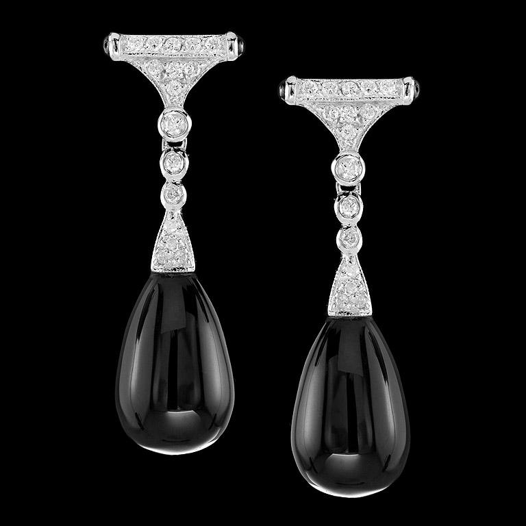 Art Deco Style Drop Earrings crafted in 9K White Gold. A pair of shiny Onyx drops 20.72 ct. swing below a pair of sparkling diamonds set (32 pcs. 0.35 ct.) and small onyx (4 pcs. 0.24 ct.) on the side. They are fashionable and you could wear