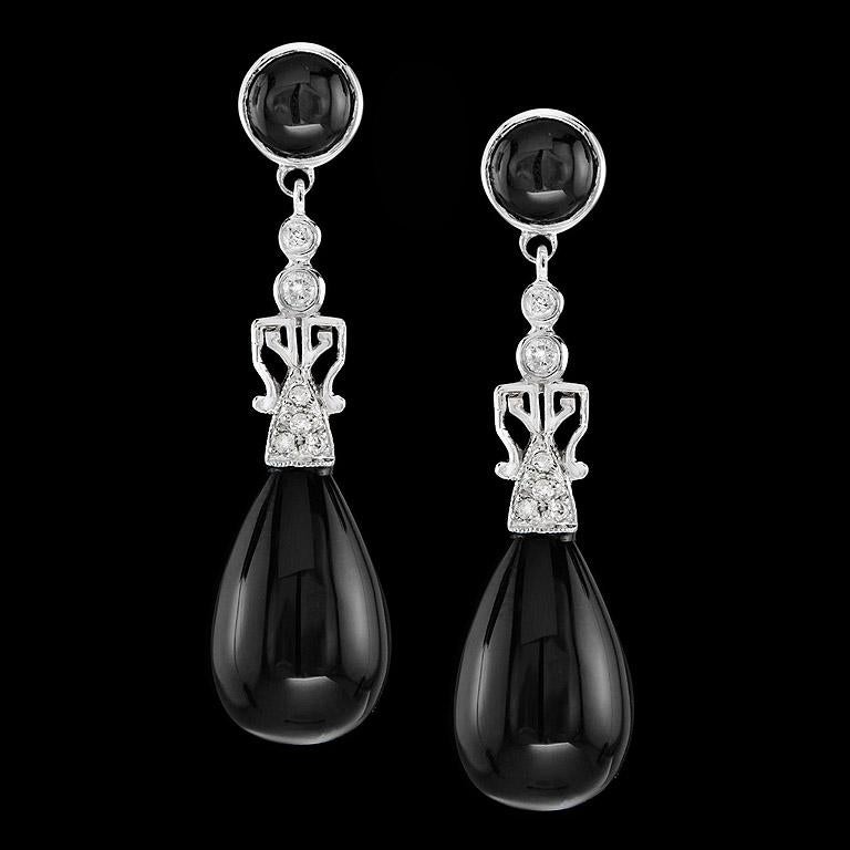 A pair of Black Onyx drops 20.72 ct. swing and sway below a pair of sparkling diamonds (12 pcs. 0.18 ct.) and round onyx (2 pcs. 1.61 ct.) setting in Art Deco Style Earrings. They are crafted in 9K White Gold. You could wear earrings everyday