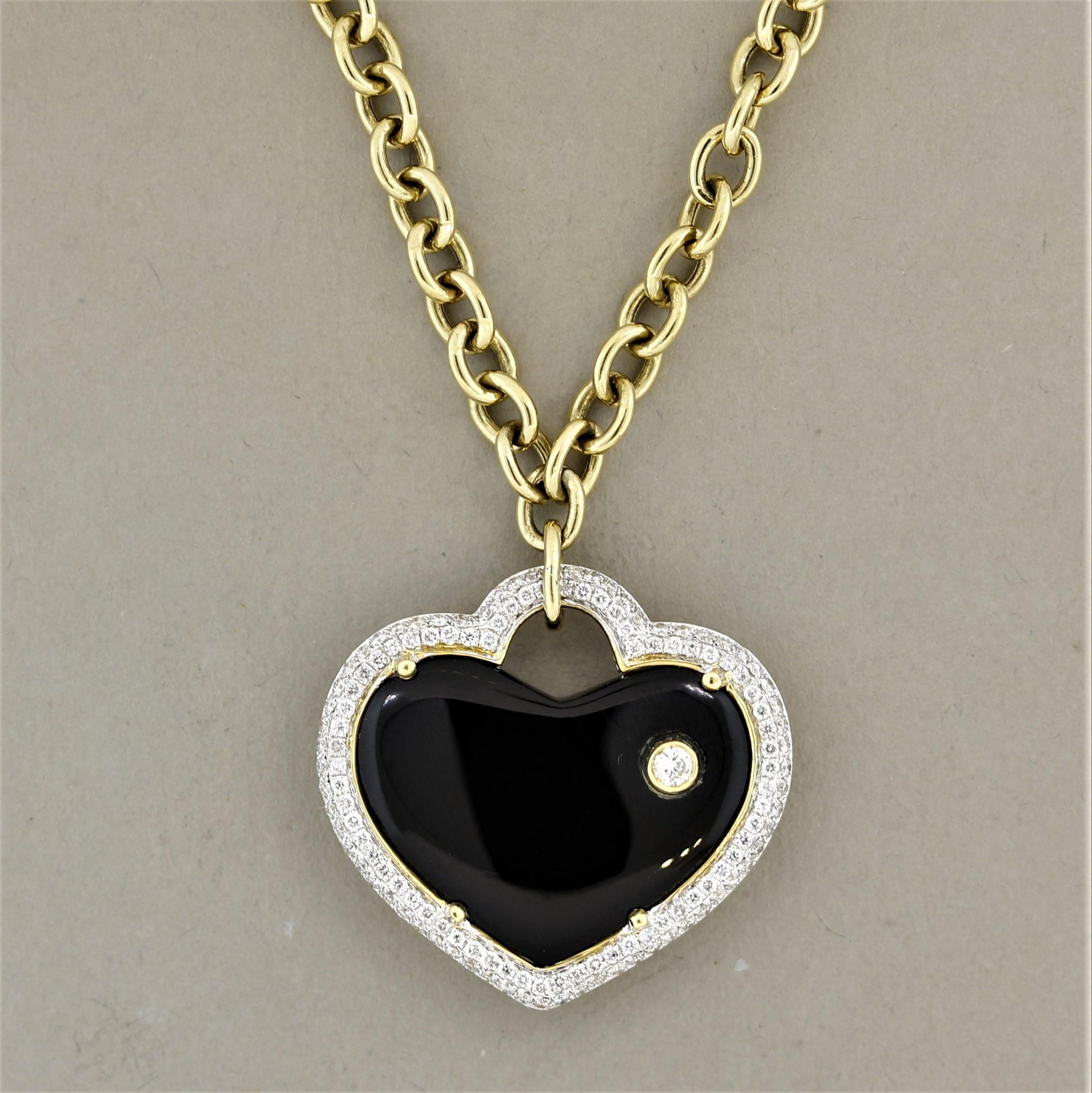 A cute and stylish necklace made in 18k gold! It features a 11.22 carat piece of black onyx which has been polished and shaped into a smooth heart shape. It is haloed by round brilliant cut diamonds as well as studded with a single larger diamond