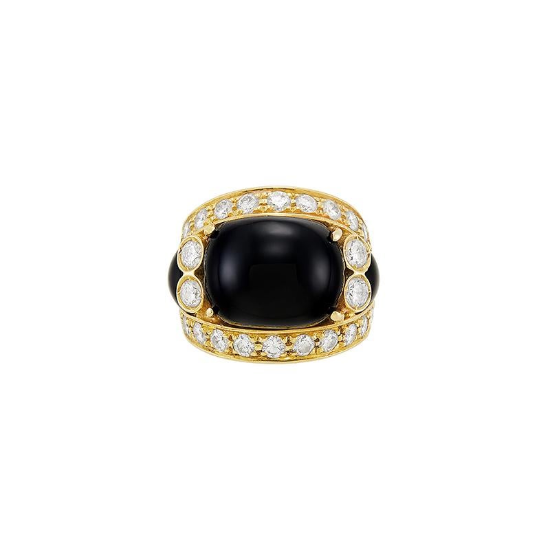 A Fine Gold, Black Onyx and Diamond Ring. Made in in France, circa 1970.
18 kt yellow gold, 34 round diamonds totalling apx. 1.95 cts., apx. 9.7 dwts. gross. 