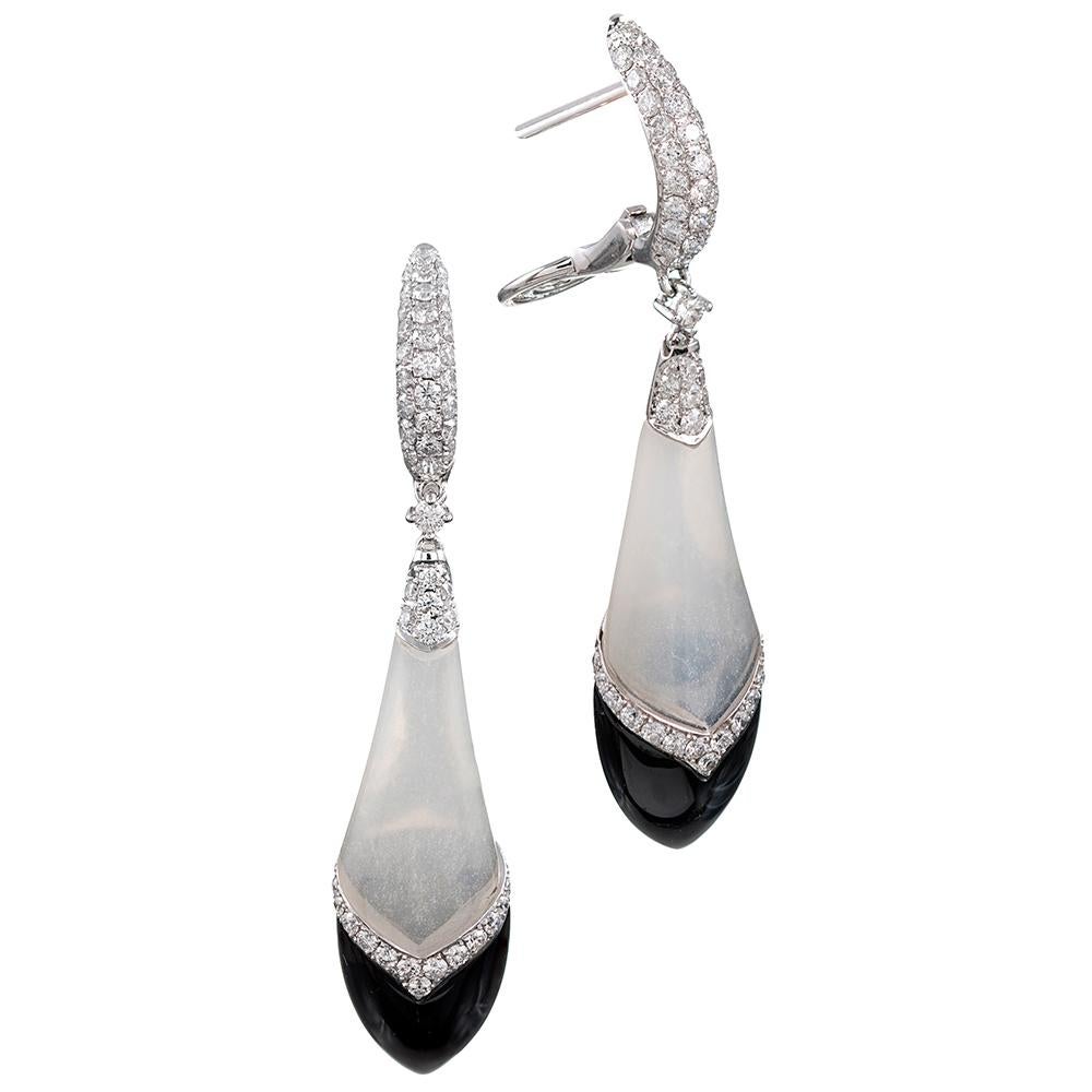 These art deco inspired earrings, sculpted of mother of pearl, onyx and brilliant diamonds make a sophisticated and beautiful statement. At 2.25 inches long, they are an elegant size which will look equally striking against a backdrop of black