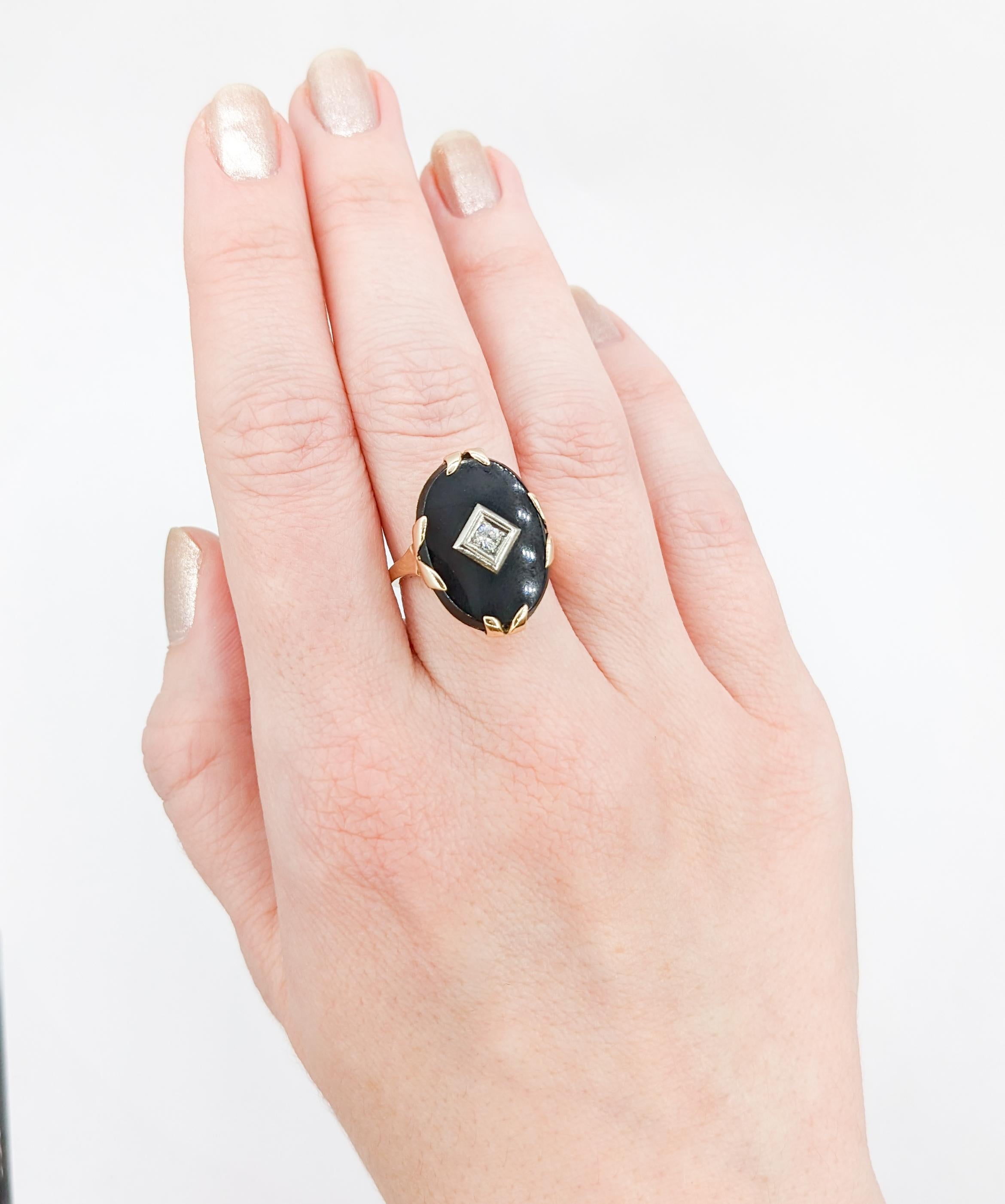 Fantastic Vintage Onyx & Diamond Ring in 10K Gold

Introducing a stunning vintage onyx ring exquisitely crafted in 10K yellow gold. This alluring piece showcases a striking 21x15mm black Onyx gemstone, offering a captivating contrast against the