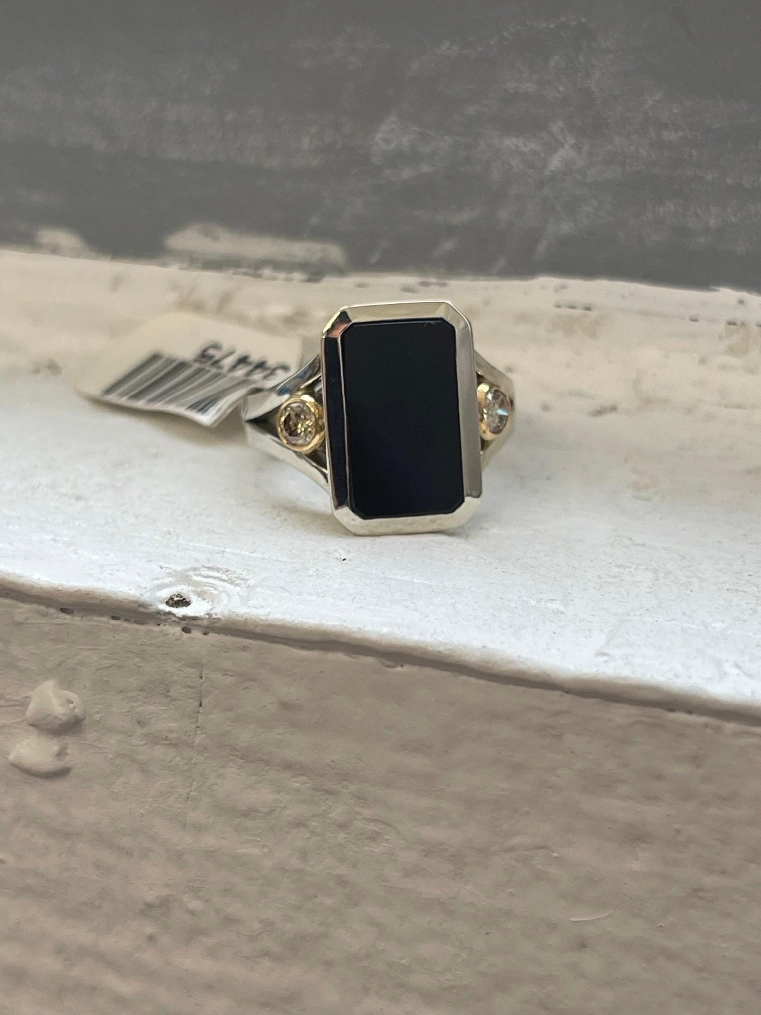 Stunning custom onyx ring with diamonds on either side in 18KT gold. This ring is modern and slick. It is size 7 and can be re-sized to any size.
The ring was made custom with a custom cut onyx to fit this style and frame, the diamonds are 0.20