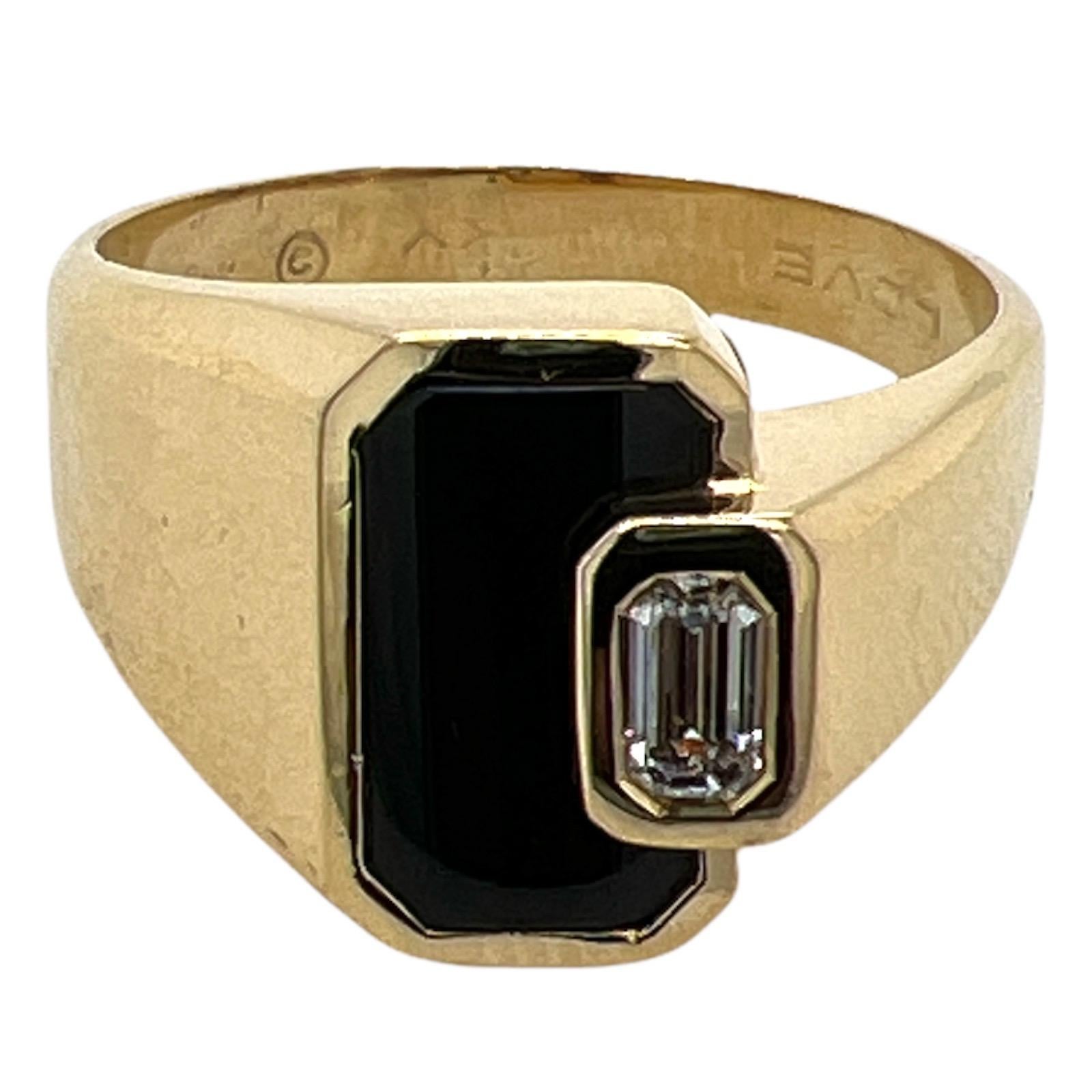 Fabulous onyx and diamond ring fashioned in 18 karat yellow gold. The ring features an emerald cut diamond weighing .30 carat and graded H color and VS clarity. The emerald cut is bezel set in a geometric fashion. The ring is currently size 11 ( can