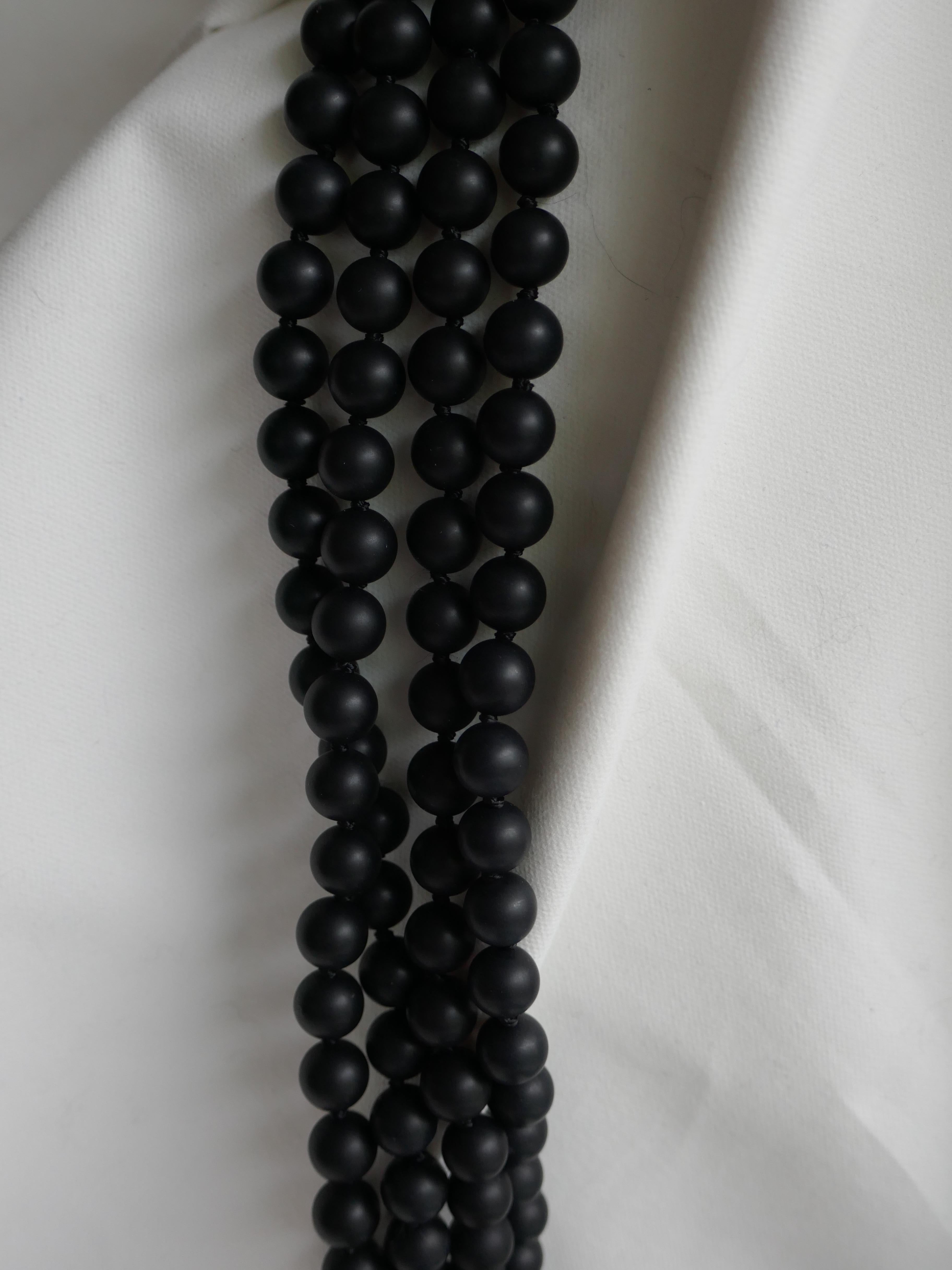 Love these necklace!!! You may wear it long, doubled or layered. 
Definitely a statement necklace. The onyx is 8mm matted and knotted on black silk thread. The closure is silk cord macrame and wood.  42 1/2 inches long. A very wearable year round