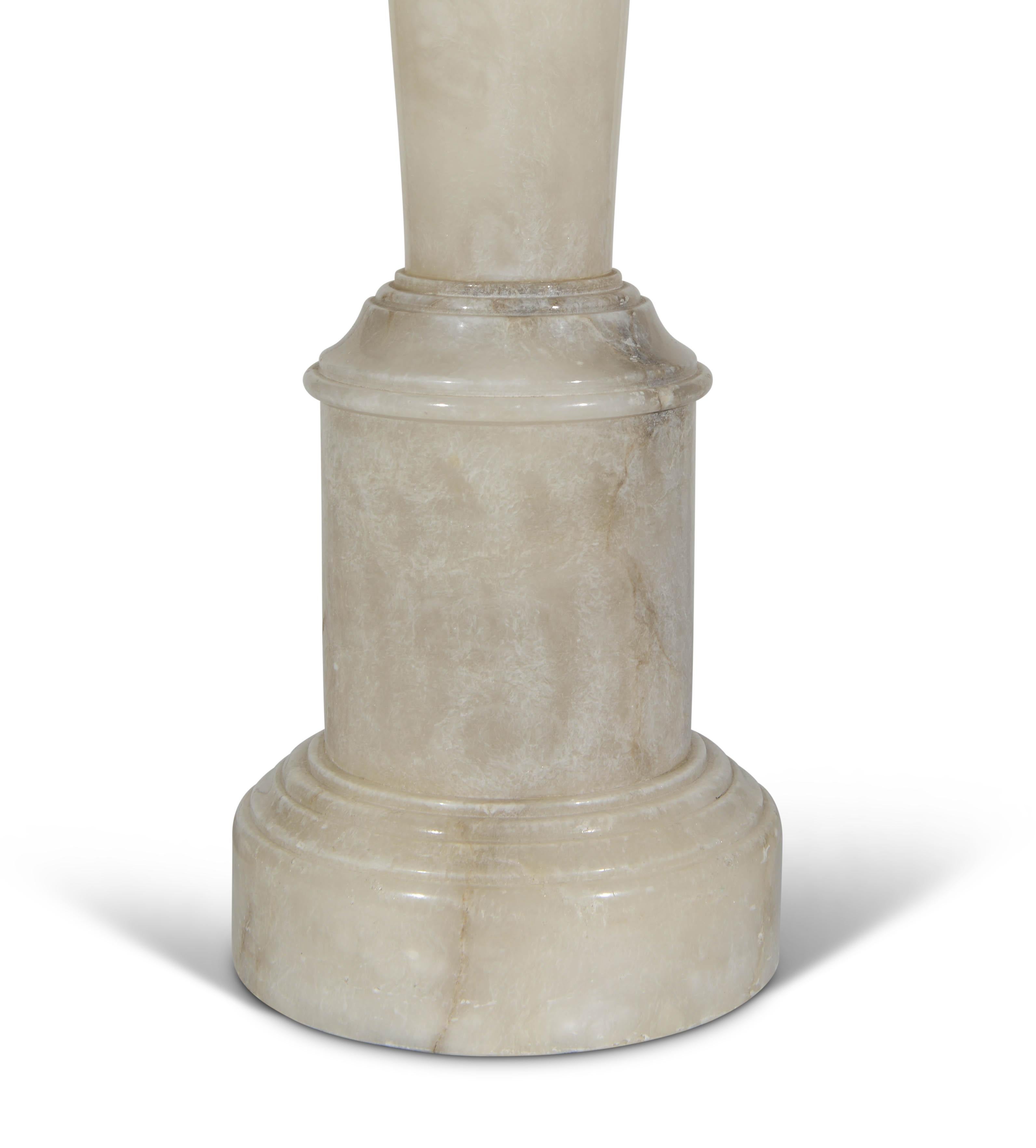 A fine early 20th century onyx column lamp with stepped plinth base. In the neo-classical taste.

Height of lamp: 24 in (61 cm) excluding electrical fitment and lampshade.

All of our lamps can be wired for use worldwide. A selection of card, linen