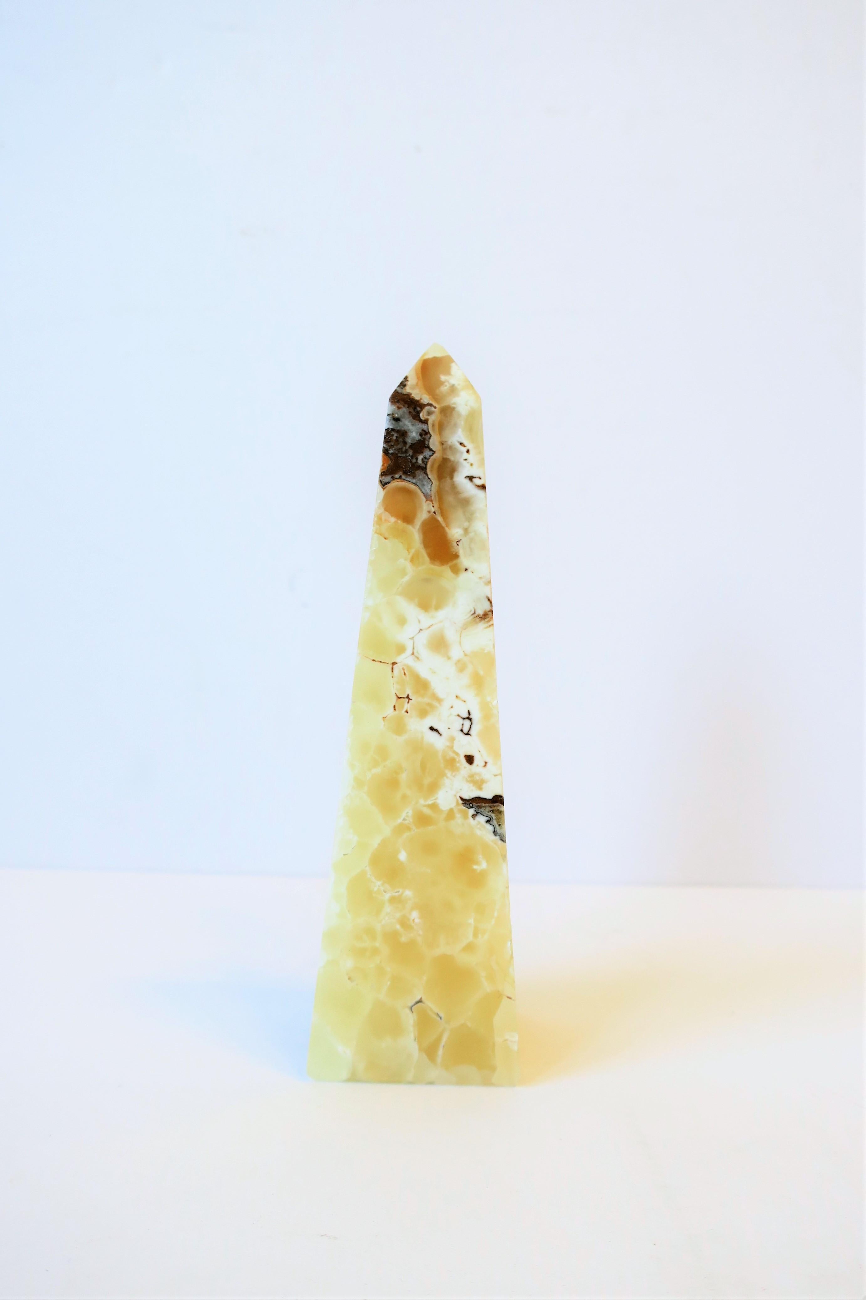 A beautiful modern onyx marble stone obelisk sculpture piece in neutral colors. Obelisk measures: 6