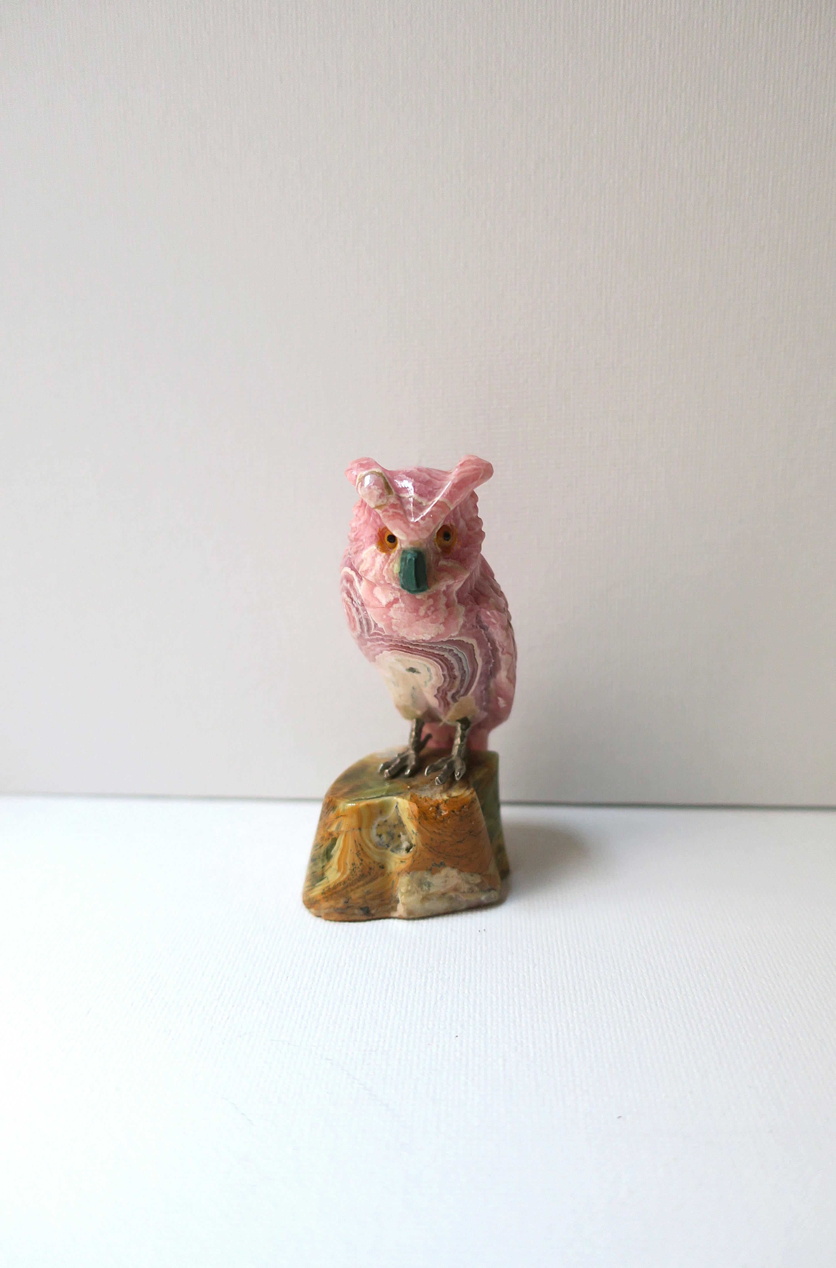 A beautifully hand-carved owl sculpture in shades of pink and white onyx with green malachite beak/nose perched atop an onyx wood-like stump. Measuring 3