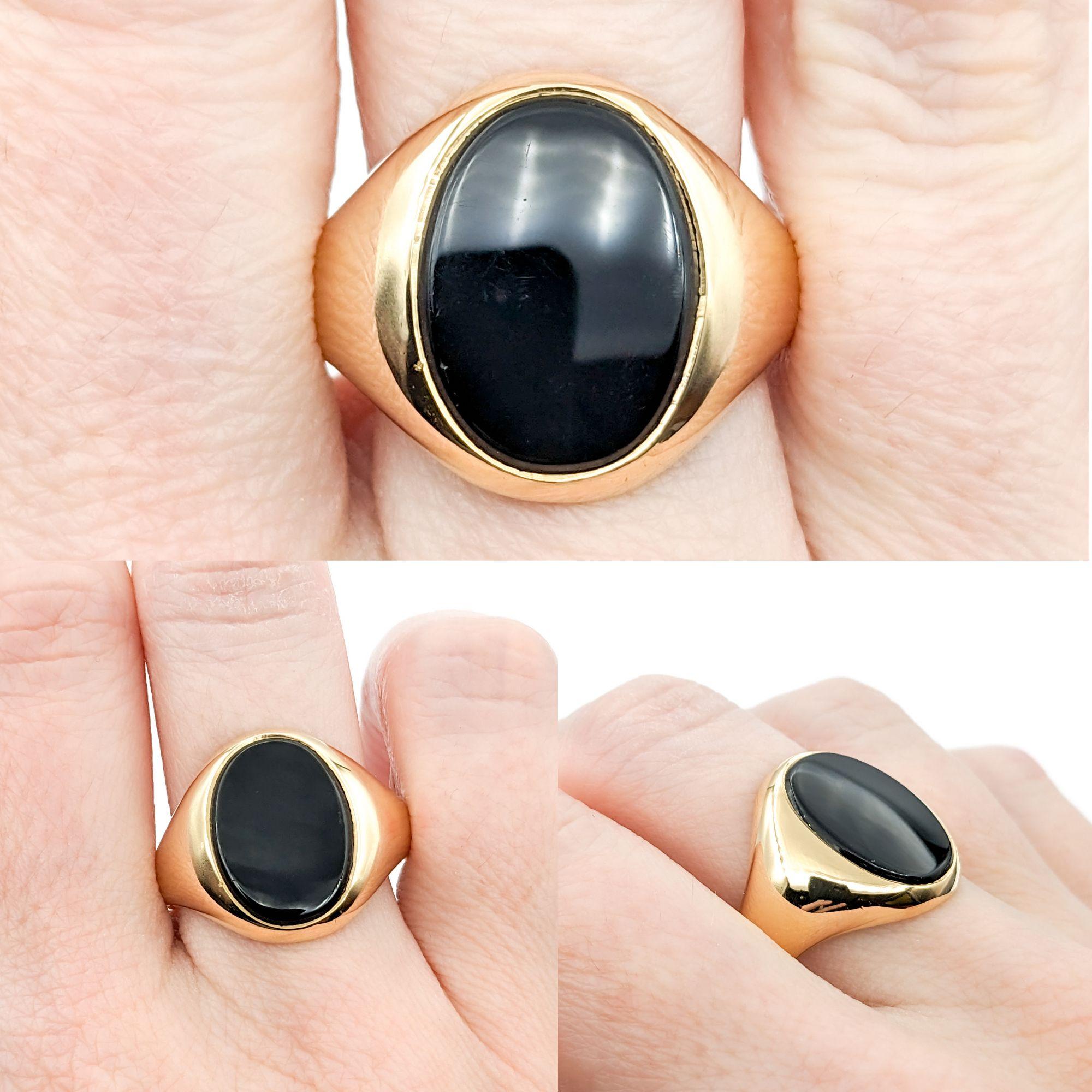Onyx Ring In yellow Gold

This sophisticated men's gemstone fashion ring is skillfully crafted in 14kt yellow gold. It showcases a prominent 16x12mm oval Onyx centerpiece, offering a sleek and bold statement. The striking Onyx is known for its deep