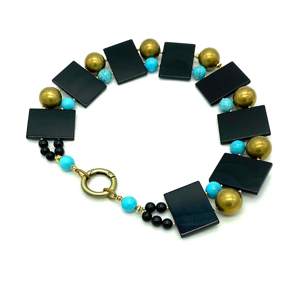 This onyx slab with turquoise and brass necklace is Nouveau Boutique's original work. We created it with eight 1.25 x 1.63 inch silky onyx slabs, 12 mm turquoise beads and 20 mm brass beads connected with a 20 mm spring ring. This Cleopatra inspired