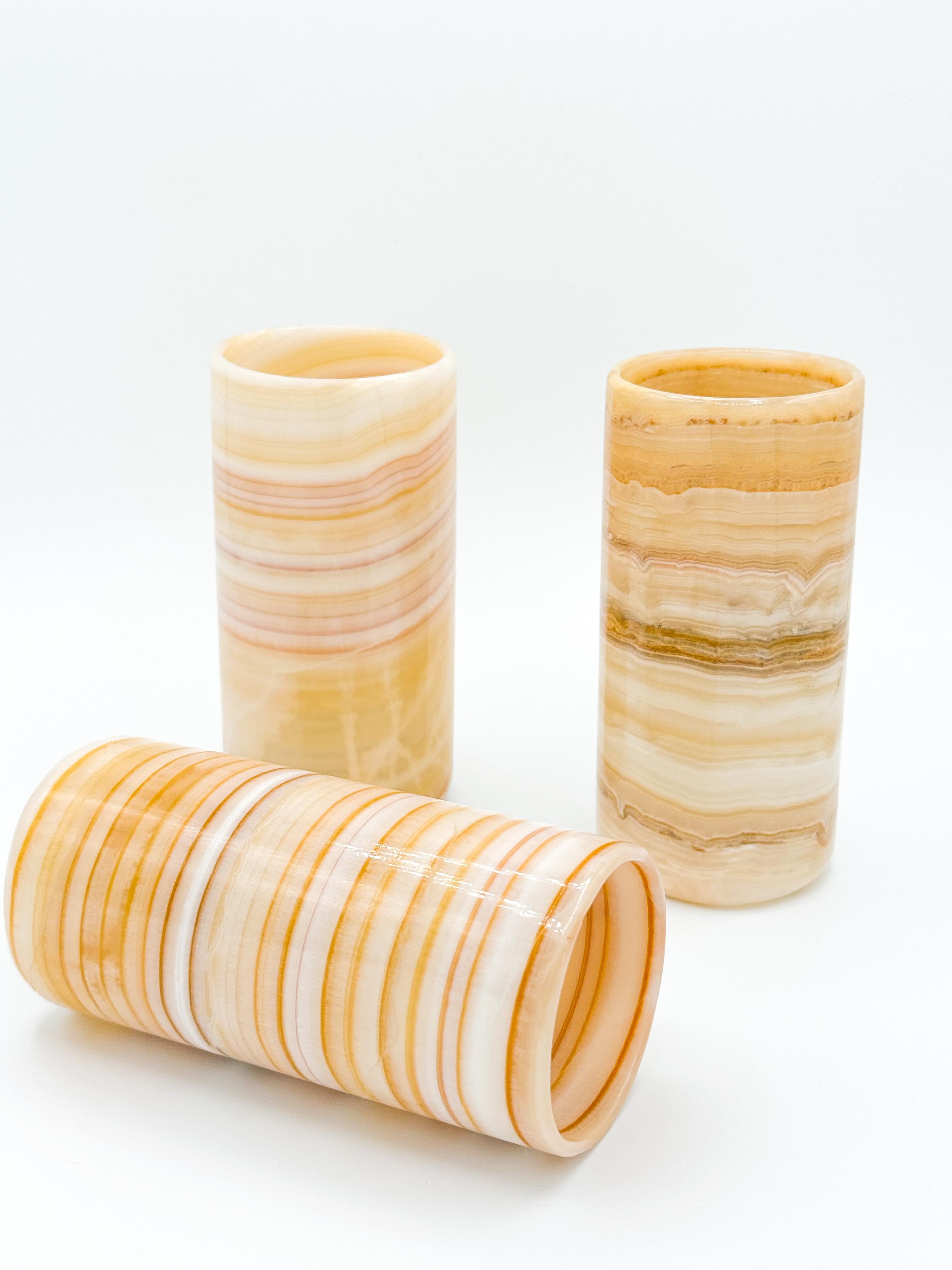 Elevate your drinkware collection with this stunning set of three Onyx Stone Tumbler Glasses bought in Mexico during the 1970s. Each piece showcases unique patterns and textures, making every glass one-of-a-kind. The rich, earthy tones and natural