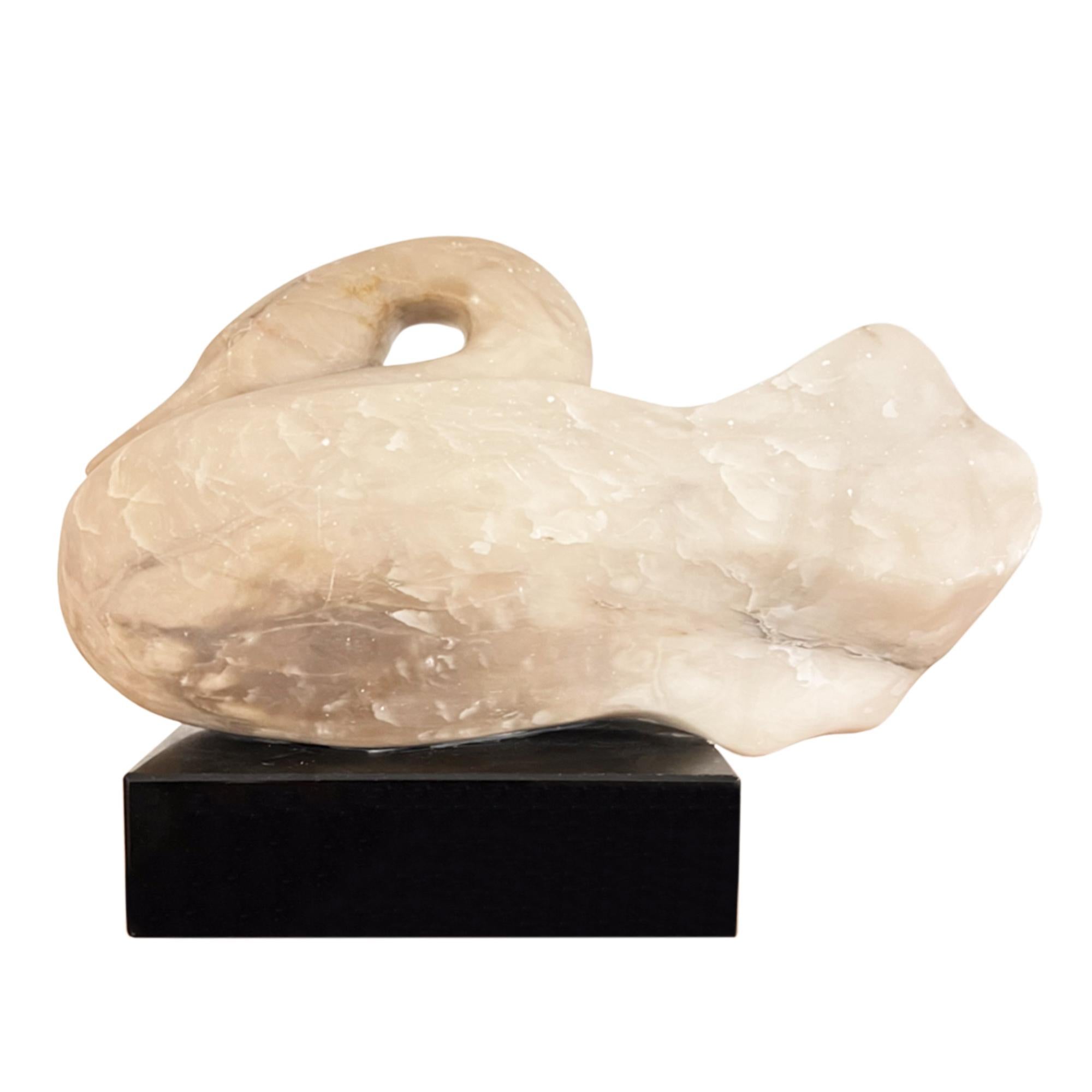 This is a beautiful sculpture of a swan crafted from a rich cream-grey onyx.

Mounted on a black rotating plinth, which allows the detail of the bird to be fully appreciated. 

A classic pose - so graceful and tactile.

The sculptor was Ralph Hurst