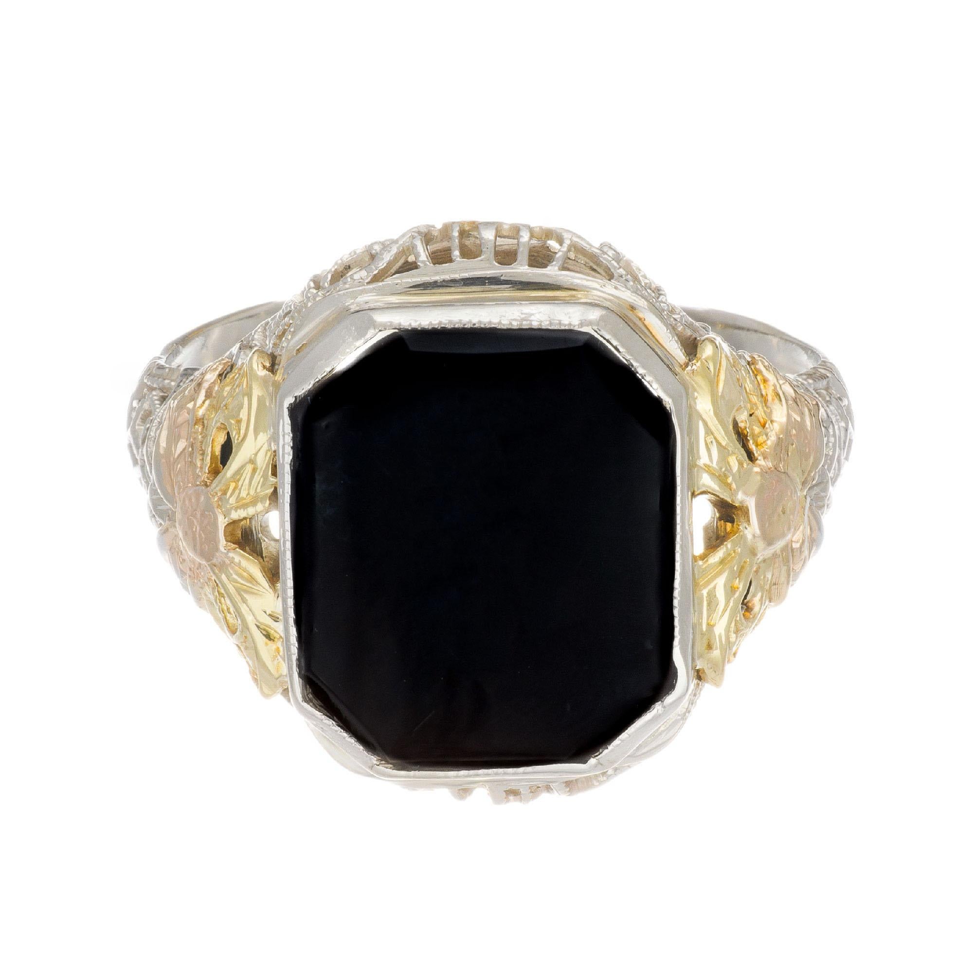 Vintage Art Deco filigree octagonal onyx ring. Set in white gold with yellow and rose gold bow designs on each side. Filigree top and bottoms with hand engraved shank. Circa 1920's.

1 octagonal black Onyx 12 x 10mm, opaque
Size 7.75 and