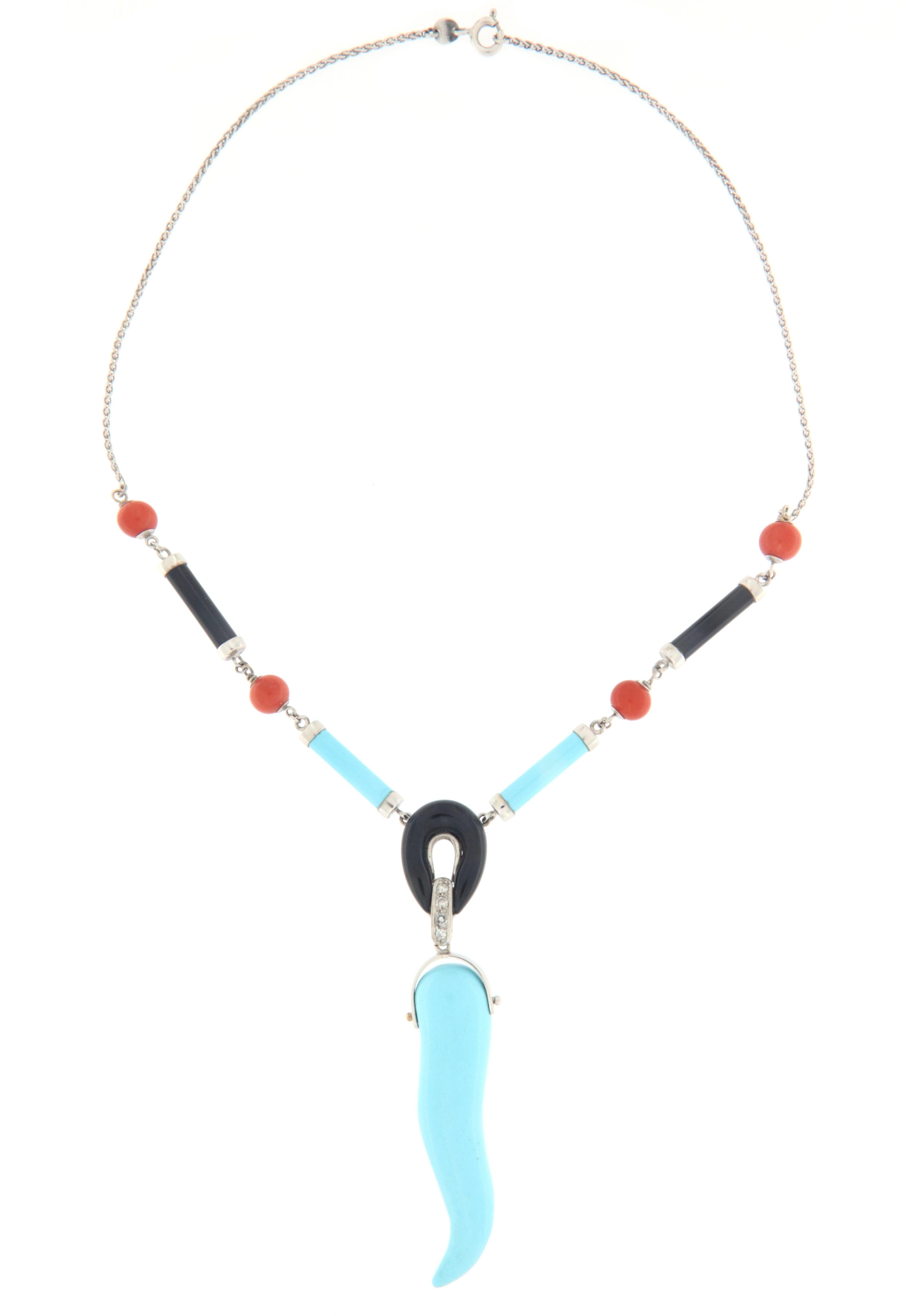 Amazing 18 karat white gold pendant necklace. Handmade by our artisans assembled with diamonds,barrels onyx and turquoise,coral bead and turquoise horn

Pendant necklace total weight 21.40 grams
Diamonds weight 0.17 karat
Coral bead size 6.65