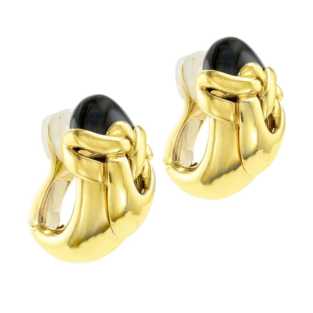Onyx and yellow gold clip-on earrings. *

ABOUT THIS ITEM:  These earrings have plenty of statement-making volume and dimensionality.  The discrete design lines integrate the black onyx and bright yellow gold in ways that make them ideal for wearing