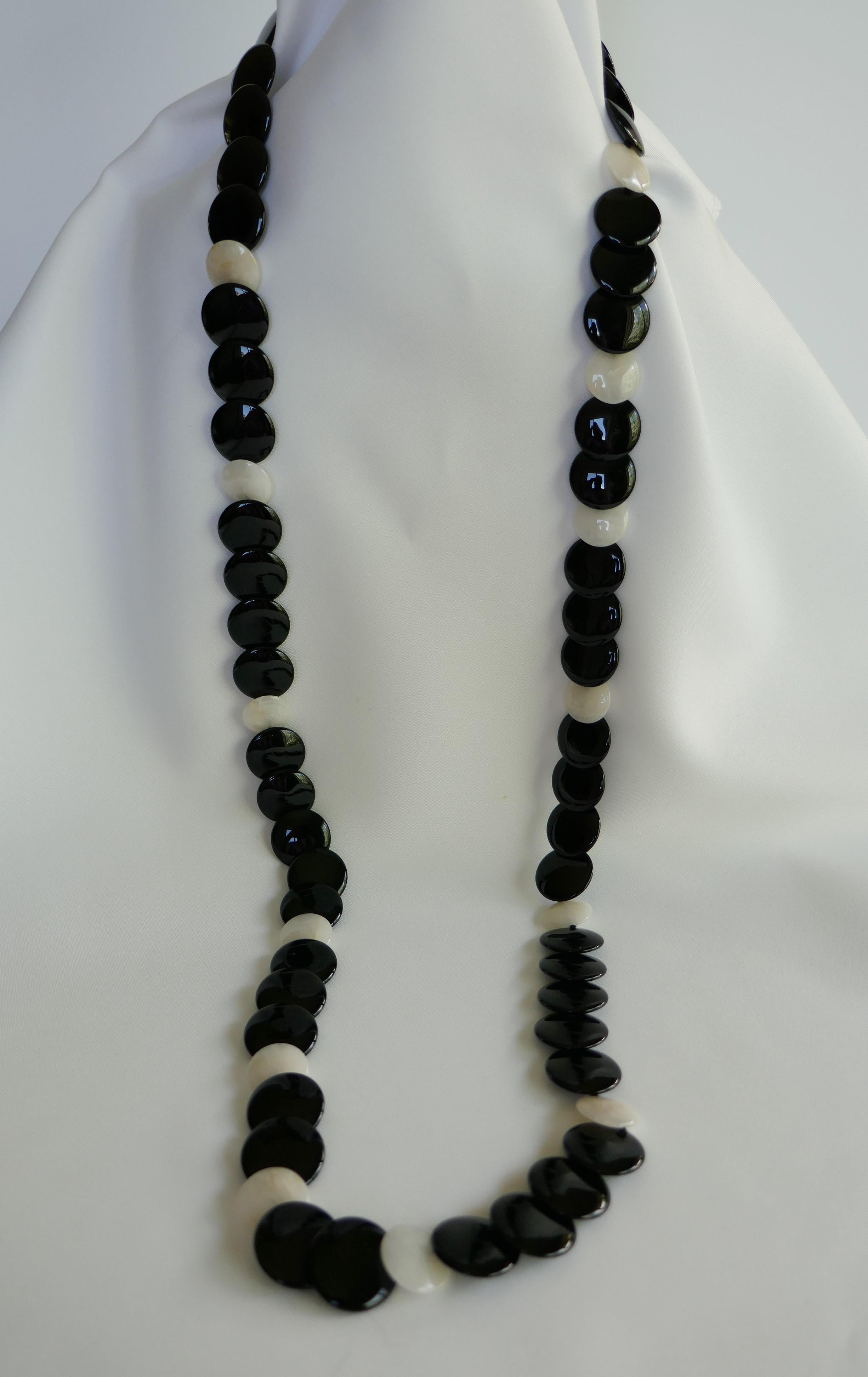 This necklace is long and may also be worn doubled and layered. The onyx is 20mm flat round disks interspersed with 16mm pale yellow jade with 925 vermeil sterling clasp. The necklace is individually knotted on black silk thread and is 41 1/2 inches