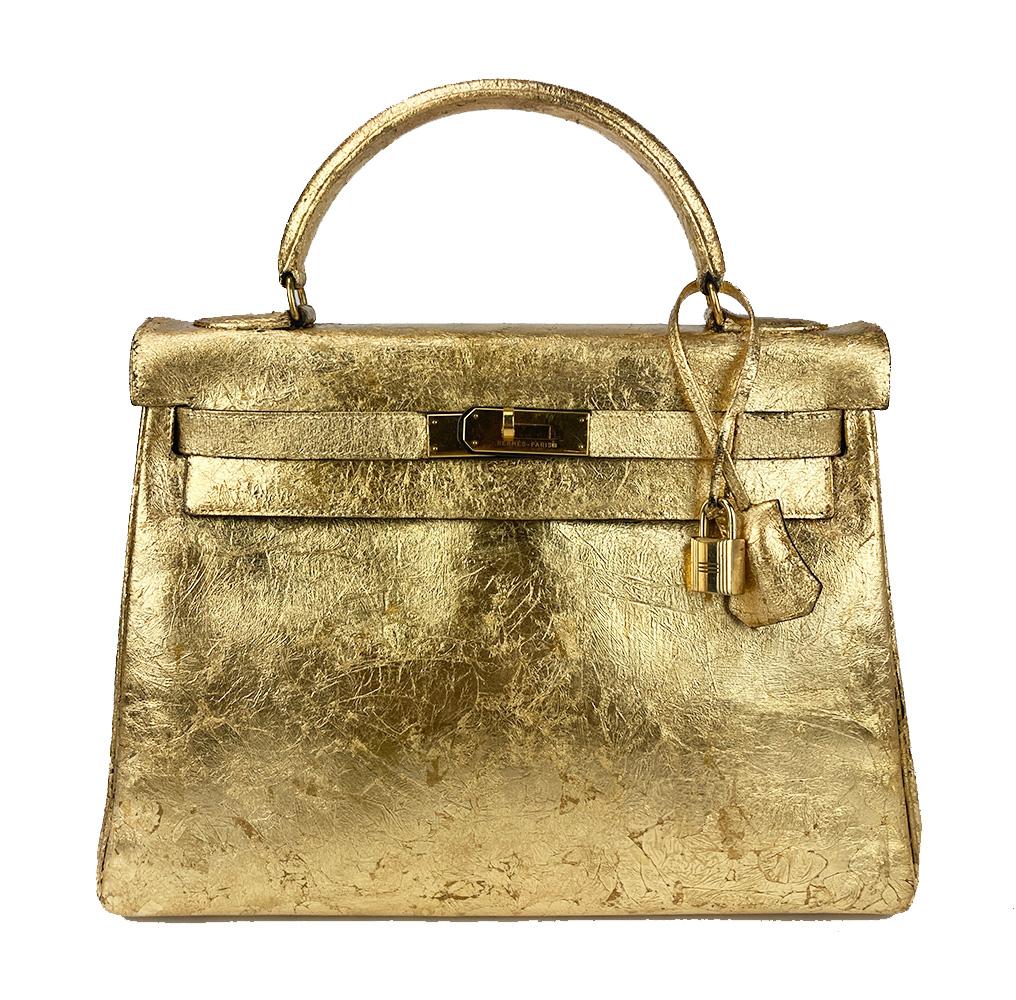 Vintage Hermes Gold foil kelly 32 in very good condition. Timeless Kelly 32 style covered in gold foil for a rare and regal look. Signature double strap flap twist closure opens to a black leather interior with 2 slit and 1 zipped side pockets.