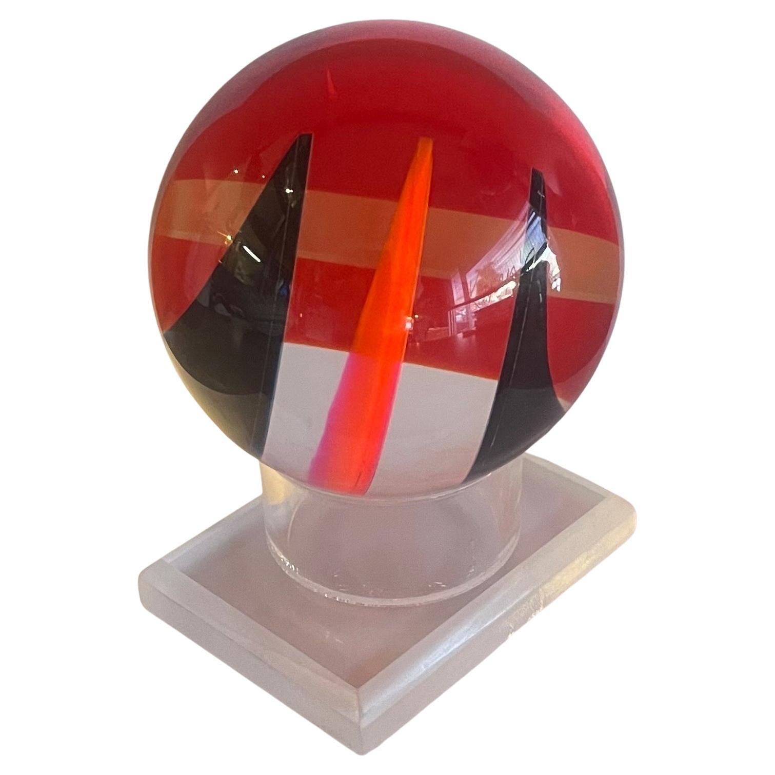 Op Art acrylic sphere sculpture on lucite base by Vasa Mihich, circa 1990. The optical look is changed by rotating the piece and letting the light refract at different angles; there are literally hundreds of different looks that can be created. The