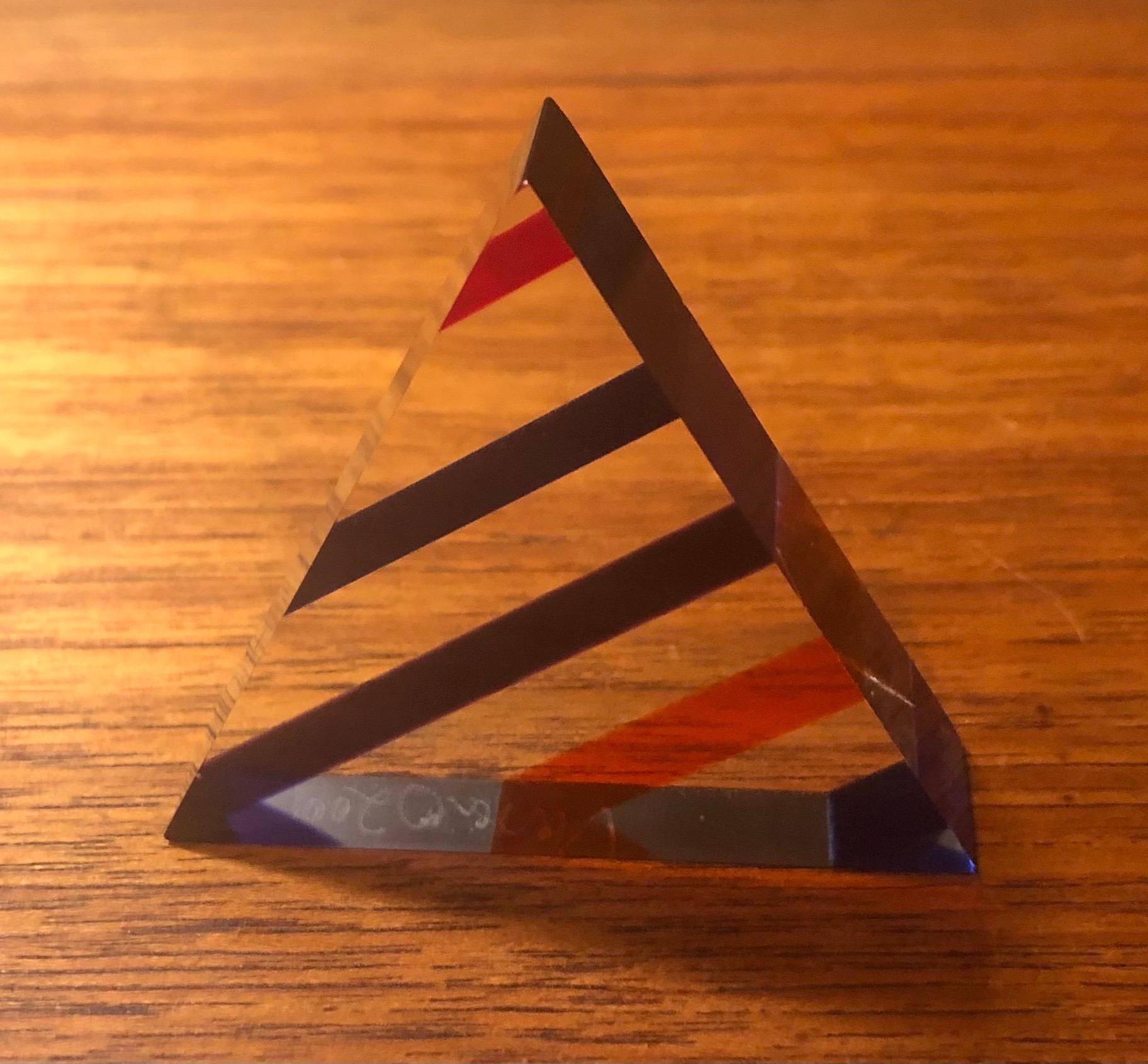 Op Art acrylic triangle pyramid sculpture / paperweight by Vasa Mihich, circa 2001. The optical look is changed by rotating the piece and letting the light refract at different angles; there are literally hundreds of different looks that can be