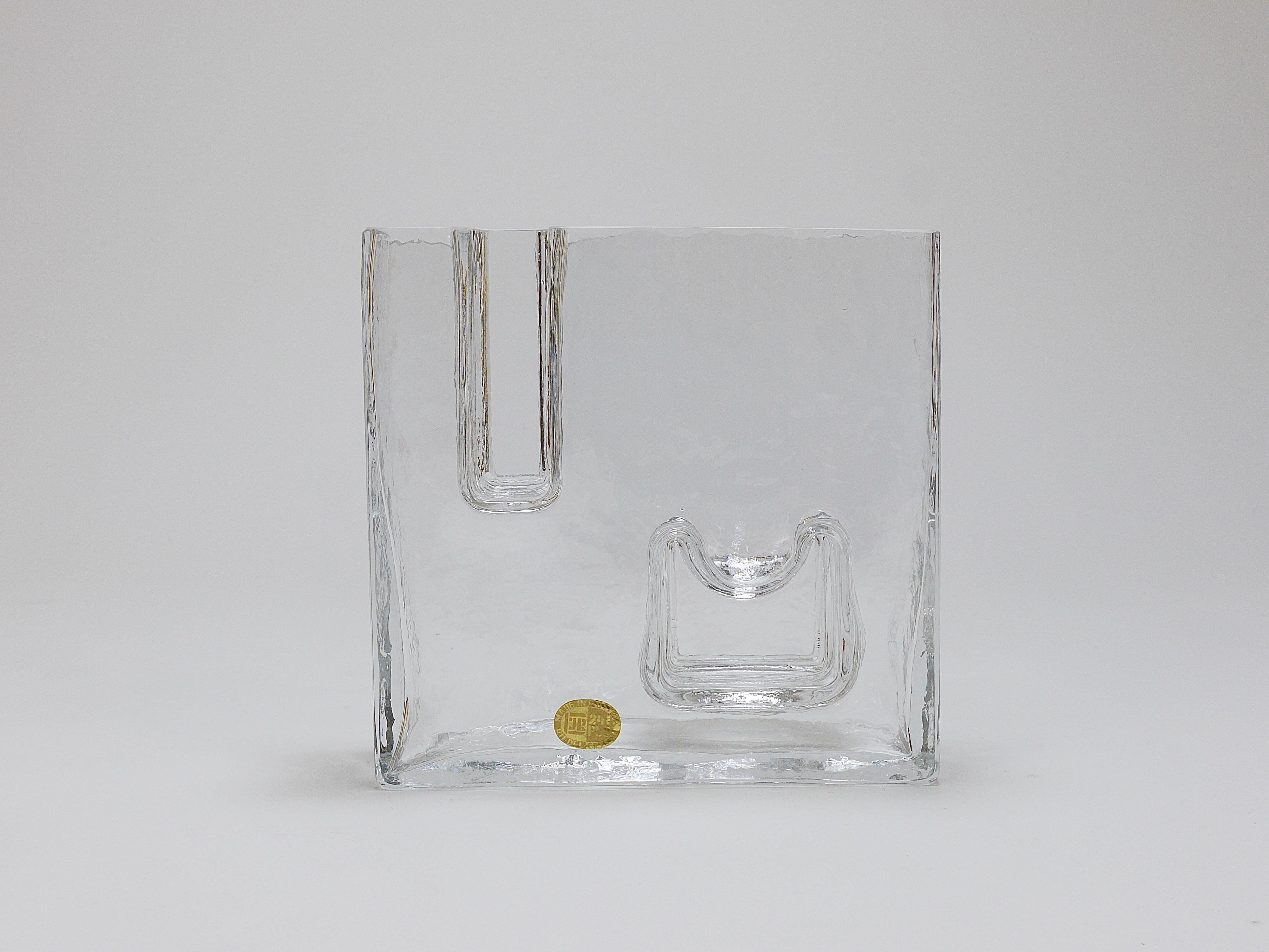 A wonderful Brutalism style geometric Op Art ice glass vase from the 1970s. Designed and executed by Claus Josef Riedel in Austria. Made of thick and solid „melting“ crystal glass. Labelled on its front and signed on its underneath, in excellent