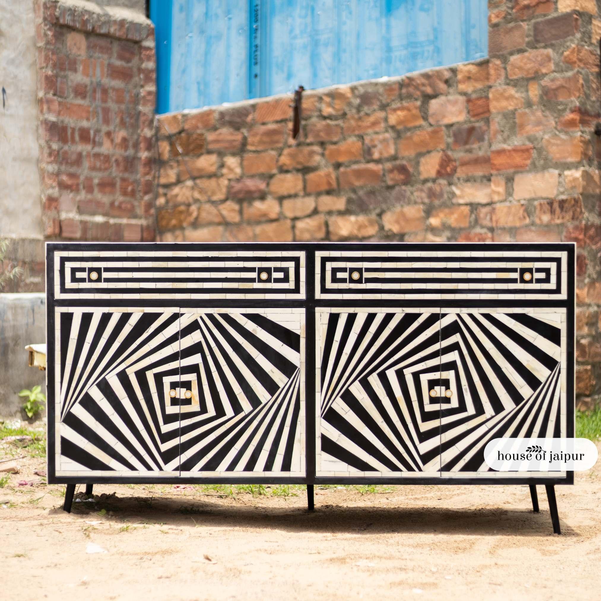 Bring a gallery-worthy statement into your home with the Op-Art Mirage Bone Inlay Sideboard, a stunning fusion of craftsmanship and visual illusion. Inspired by the Op-Art movement of the 1960s, this design uses bold black-and-white geometric
