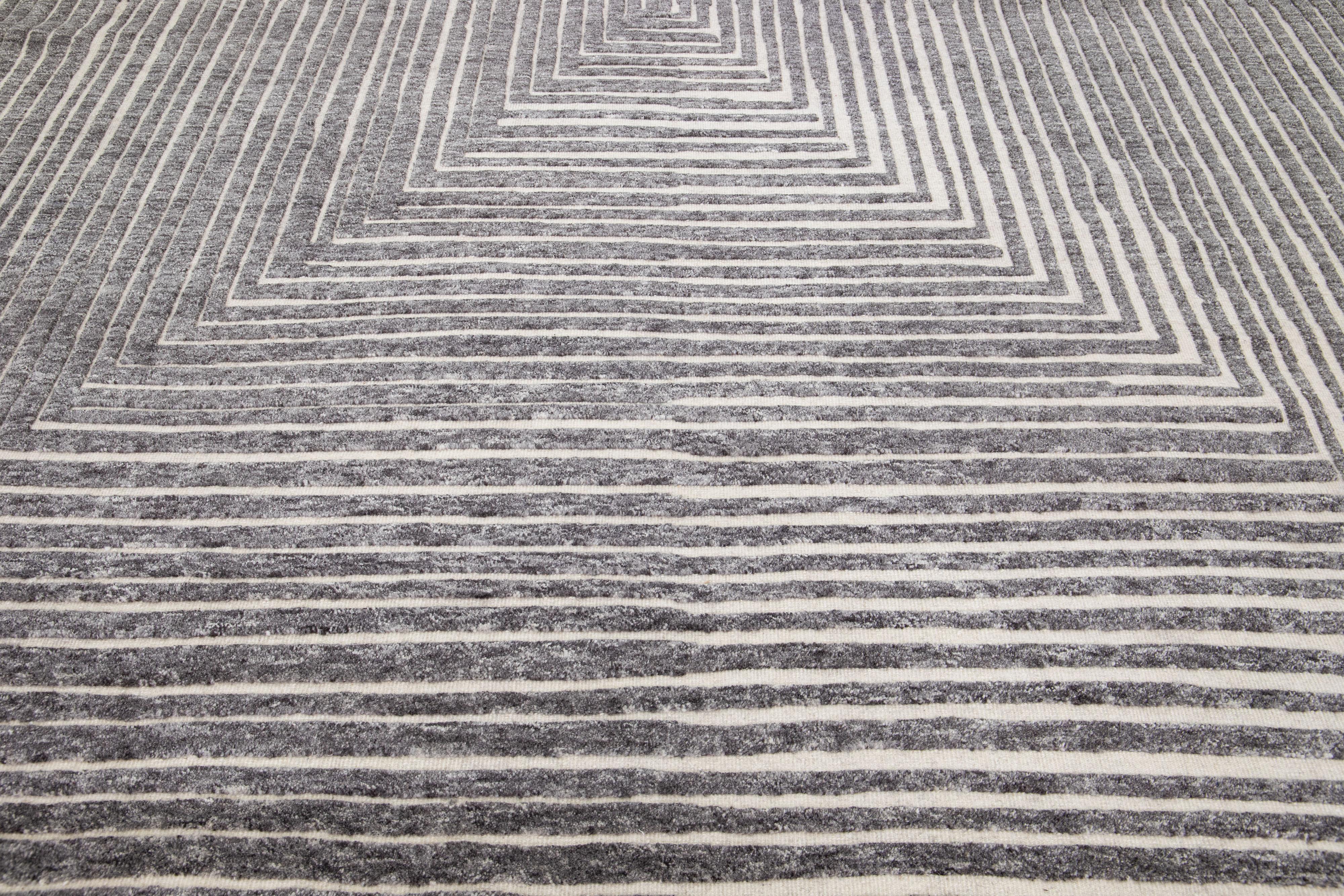 Beautiful modern Moroccan-style hand-knotted wool rug with a beige color field. This rug is part of our Apadana's Safi Collection and features an Op Art squares seamless design in gray.

This rug measures: 10'3
