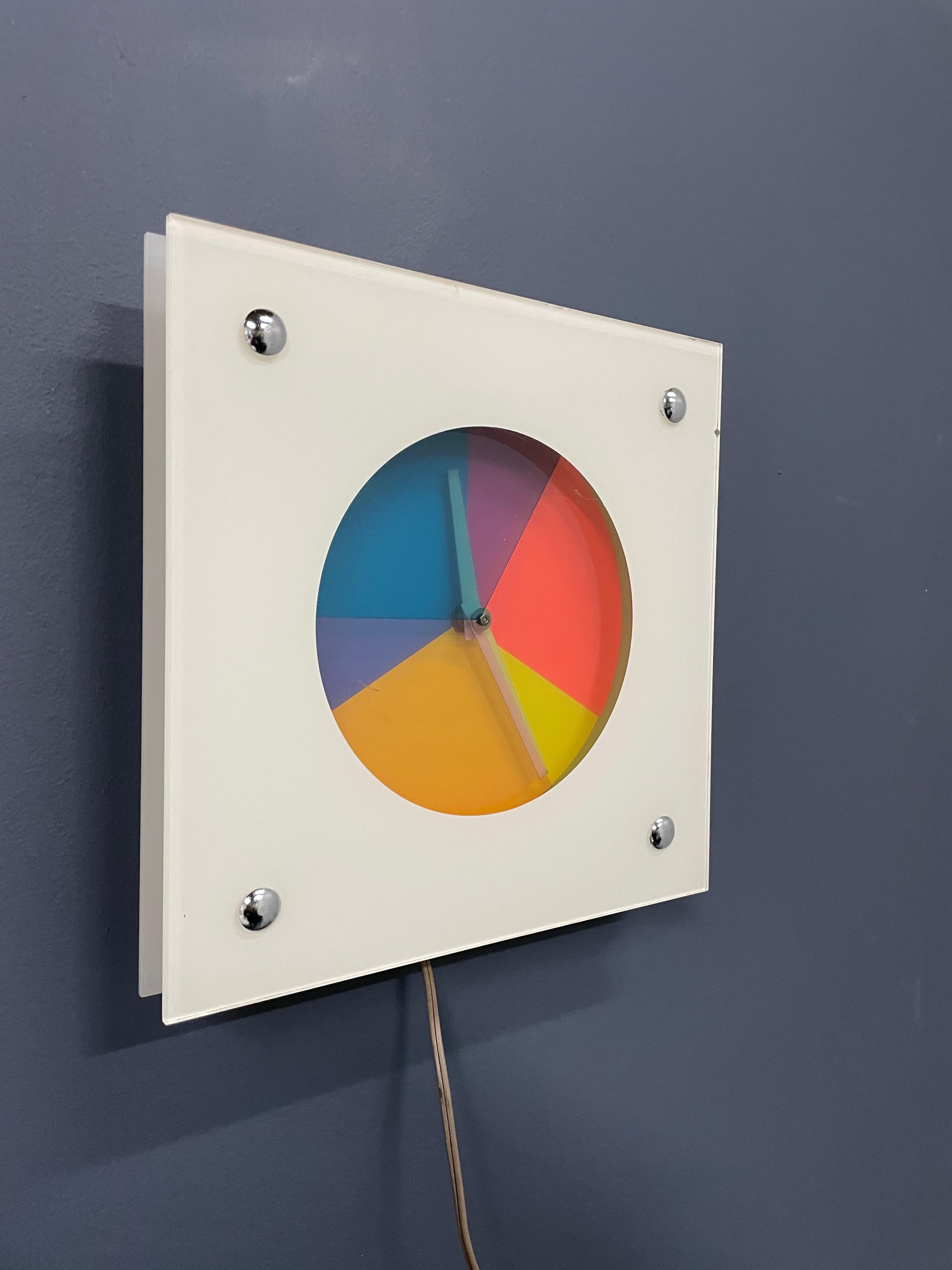 Super rare clock manufactured by Peam of New York, this clock in a glass frame has rotating pieces of colored lucite that rotate to make a kaleidoscope movement, see video.