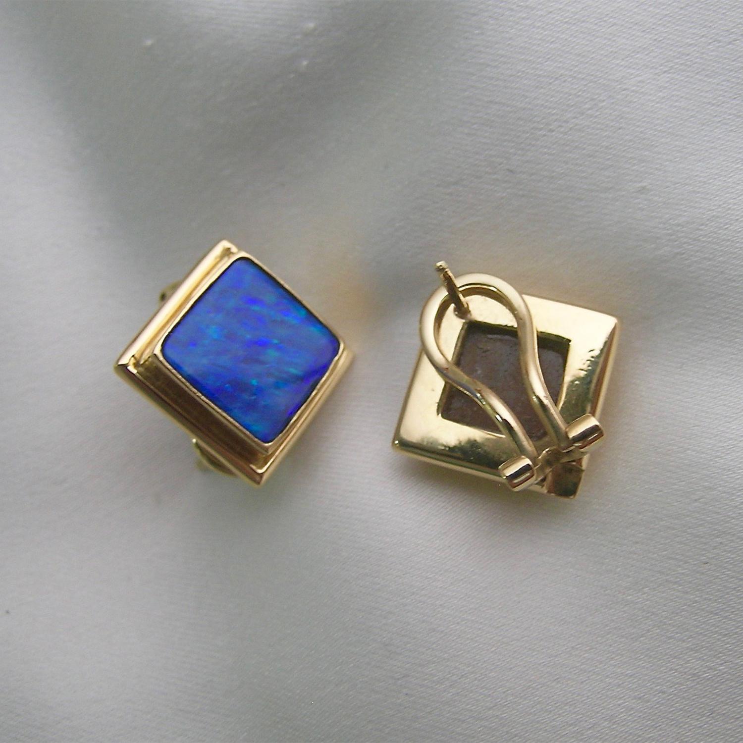 Simple, yet elegant,  these square opal earrings sit directly on the ear.  No diamonds makes them an everyday, casual piece of jewelry.  Light weight and colorful, using 12 carats of boulder opals.  We cut these opals to fit into our shape of