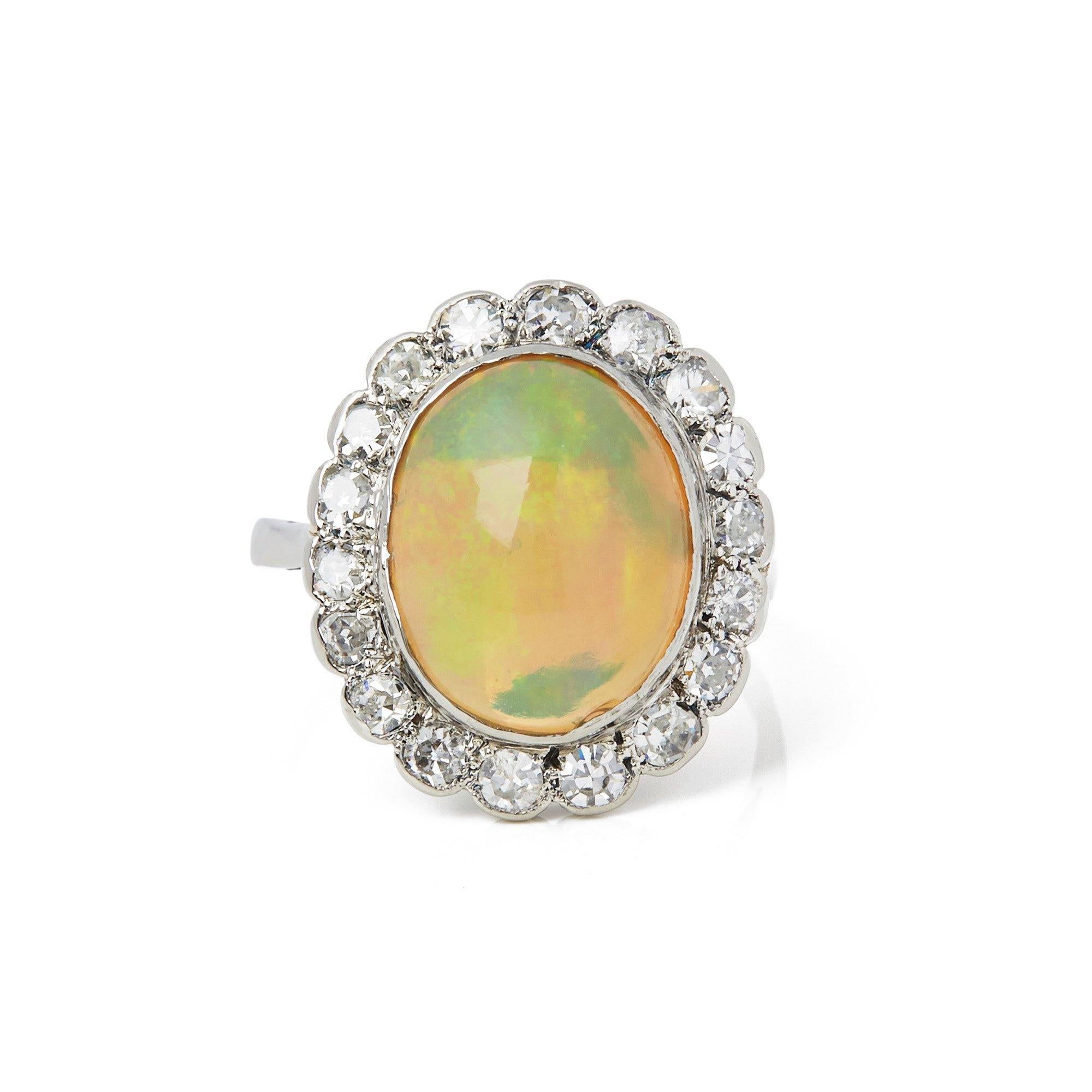 This Ring features One Oval Opal surrounded by Eighteen Round Brilliant Cut Diamonds totalling 1.26cts. Mounted in an 18k White Gold Claw Setting. Complete with Xupes Presentation Box. Our Xupes reference is COMJ232 should you need to quote this.