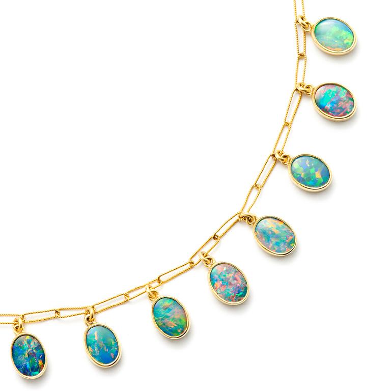 Nine brilliant, bezel set Opals dangle delicately from an 18 Karat Gold link chain.

Individual Stone Size: 8.2 mm wide x 13.75 mm high

Length of Necklace: 18”