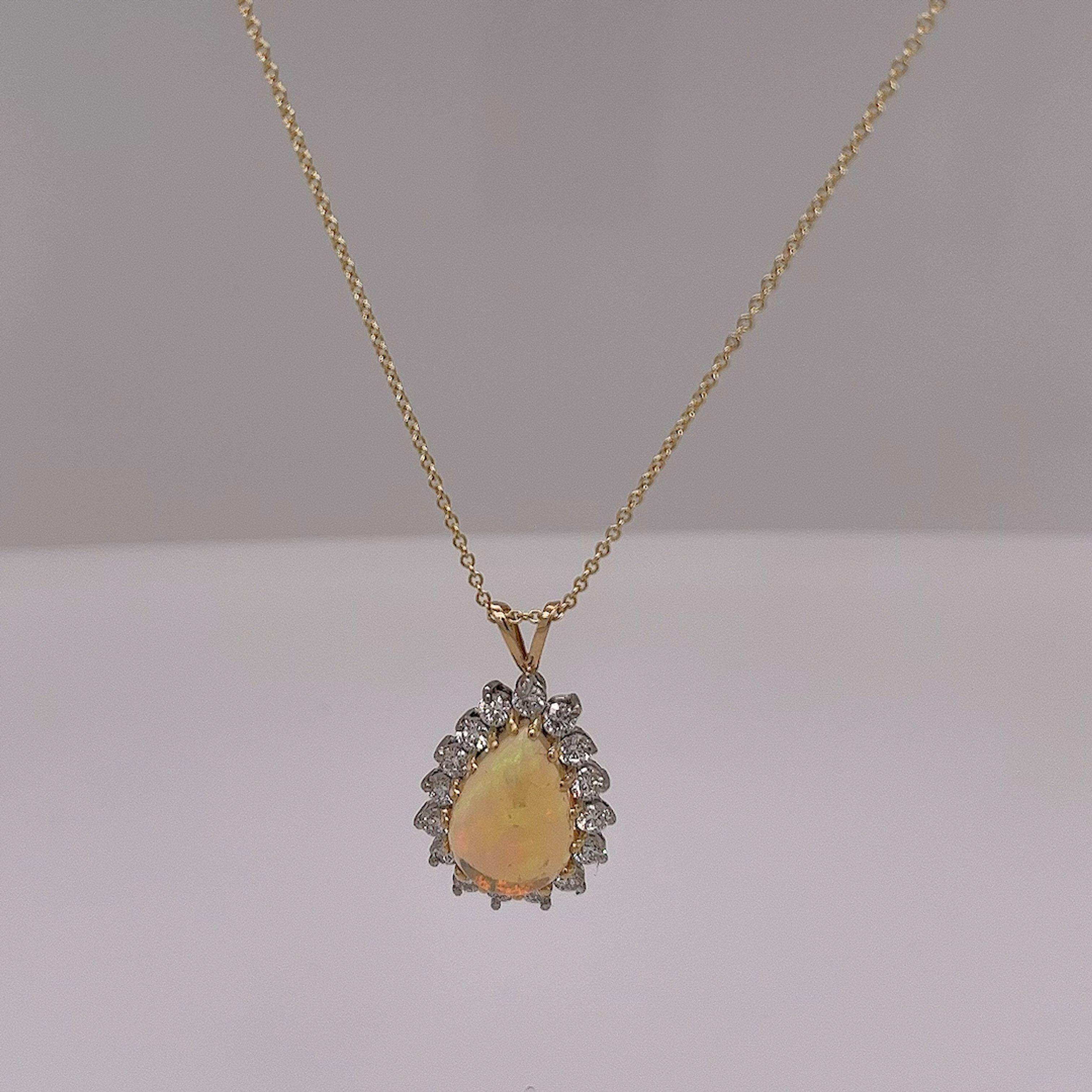 This gorgeous opal & diamond pendant is set with 1.50ct pear shape opal and 18 round brilliant cut diamonds in 18ct yellow gold setting.
The pendant is suspended from an 18ct yellow gold chain that measures 18 inches adjustable at 16