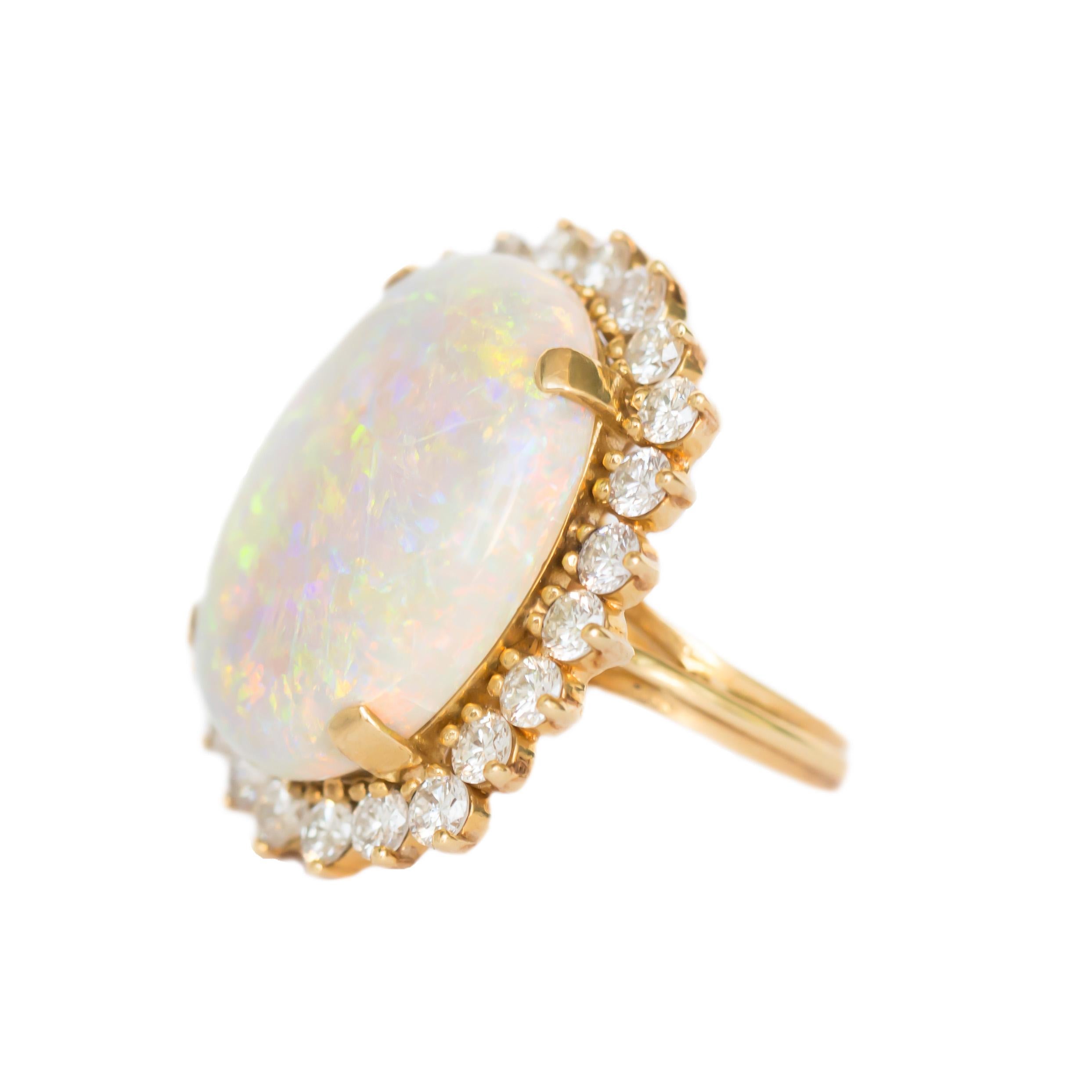 Item Details: 
Ring Size: 6.75
Metal Type: 18K Yellow Gold
Weight: 15.9 grams

Side Stone Details: 
Shape: Round Brilliant
Total Carat Weight: 3.00 carat, total weight
Color: F
Clarity: VS

Color Stone Details: 
Type: Opal
Shape: Oval Shape
Carat