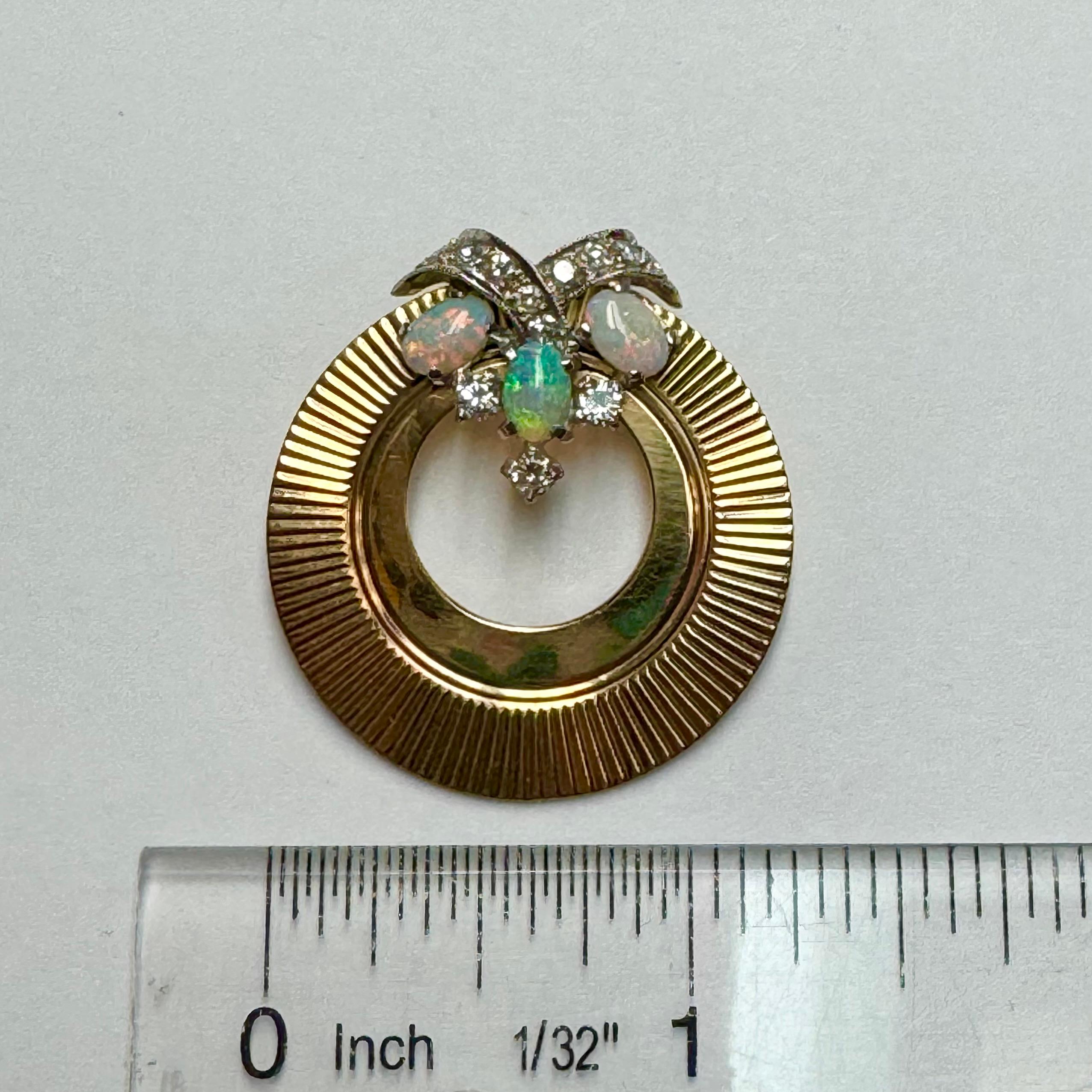 Gorgeous , one of a kind opal diamond pendant in 14k yellow and white gold. The pendant is created from a fluted golden disc, with the top adorned with 3 fiery opals and 11 round brilliant diamonds. This unique design is both bold and simple as