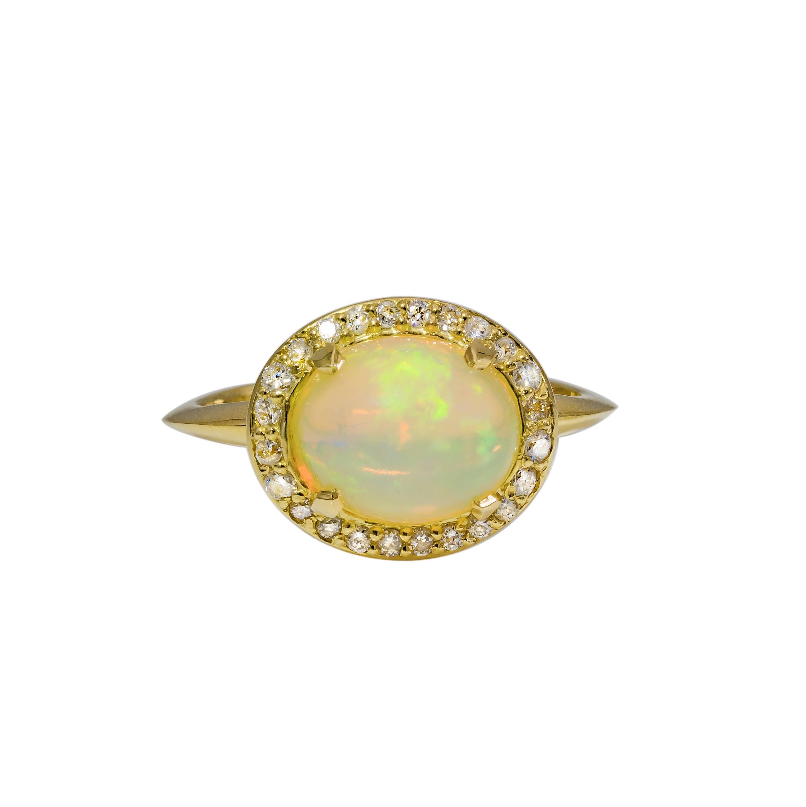 This ring is lovely and special as the combination of the dreamy opal is magnified by the multitude of diamonds set in warm 18k gold. This stunning opal is from Ethiopia and is aprox. 2.25 ct. and surrounded by a halo of bright white diamonds that