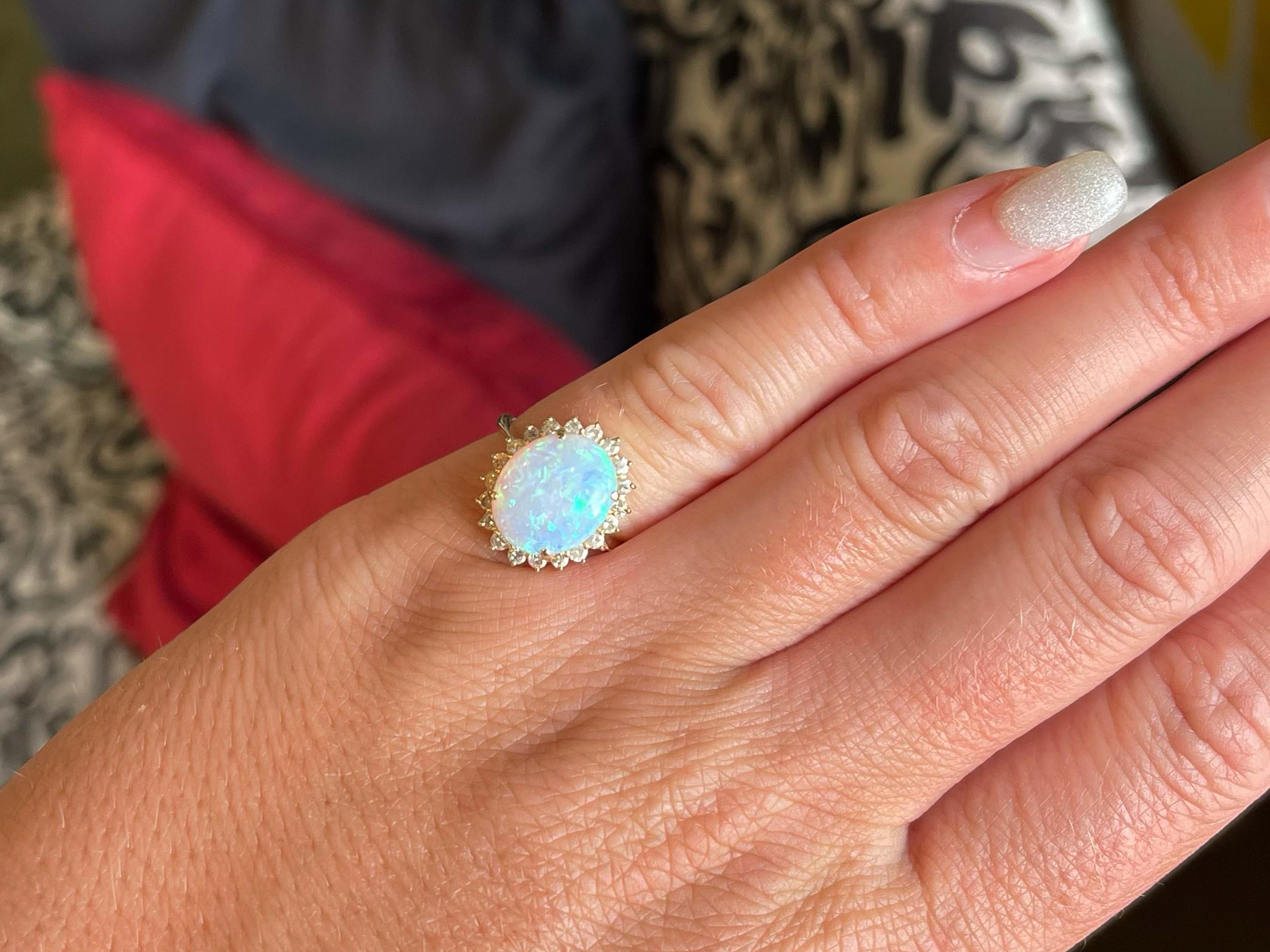 Item Specifications:

Metal: 14K Yellow Gold 

Total Weight: 3.3 Grams

Gemstone Specifications:

Center Gemstone: Opal

Gemstone Measurements: ~12.2 mm x 10.16 mm x 2.97 mm

Gemstone Carat Weight: ~2.09 carats

Diamond Count: 20

Diamond Color: