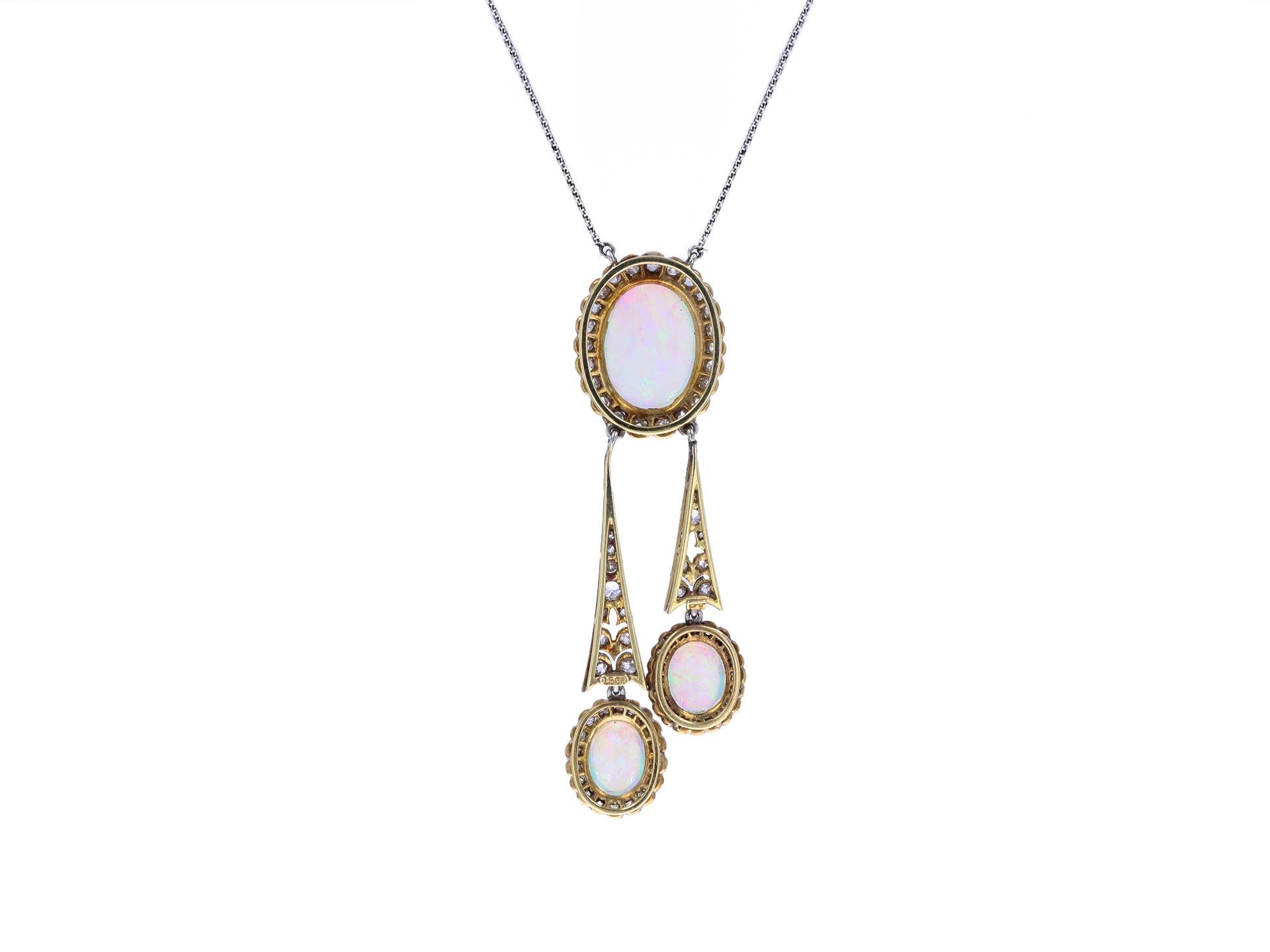 Opal and diamond negligée necklace. Centrally set with an oval cabochon natural opal in a open back rubover setting with an approximate weight of 3.90 carats, further set with two oval cabochon natural opals in open back rubover settings with a