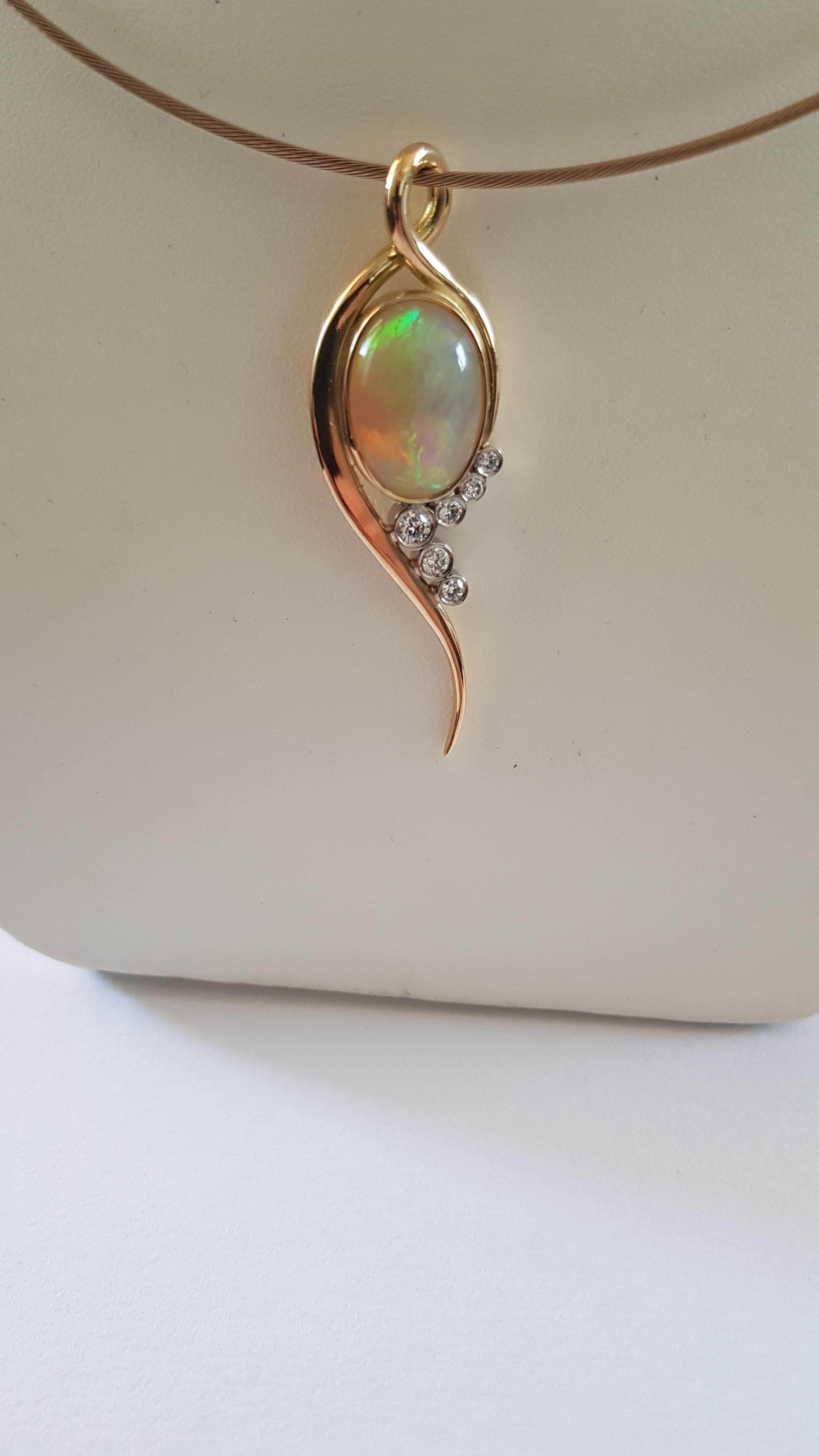 Stunning Welo opal with fantastic colour saturation set into 18ct yellow gold bezel setting with Brilliant cut Diamonds of  FVS1 and approx 0.60pt  Diamonds set into 18ct white gold bezel set total all handmade by ourselves in the uk . A very