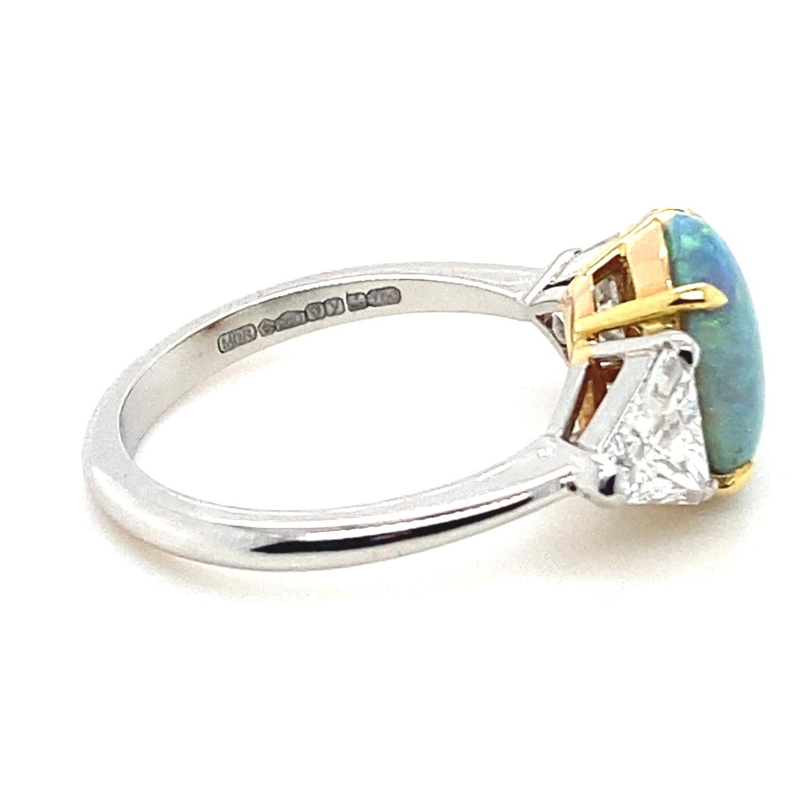 An opal and diamond platinum ring

This beautiful opal and diamond ring is handcrafted in platinum. The piece is set to its centre in contrasting yellow gold claws with a round cabochon cut opal of 1.93cts.
 
The opal is framed on either side with a