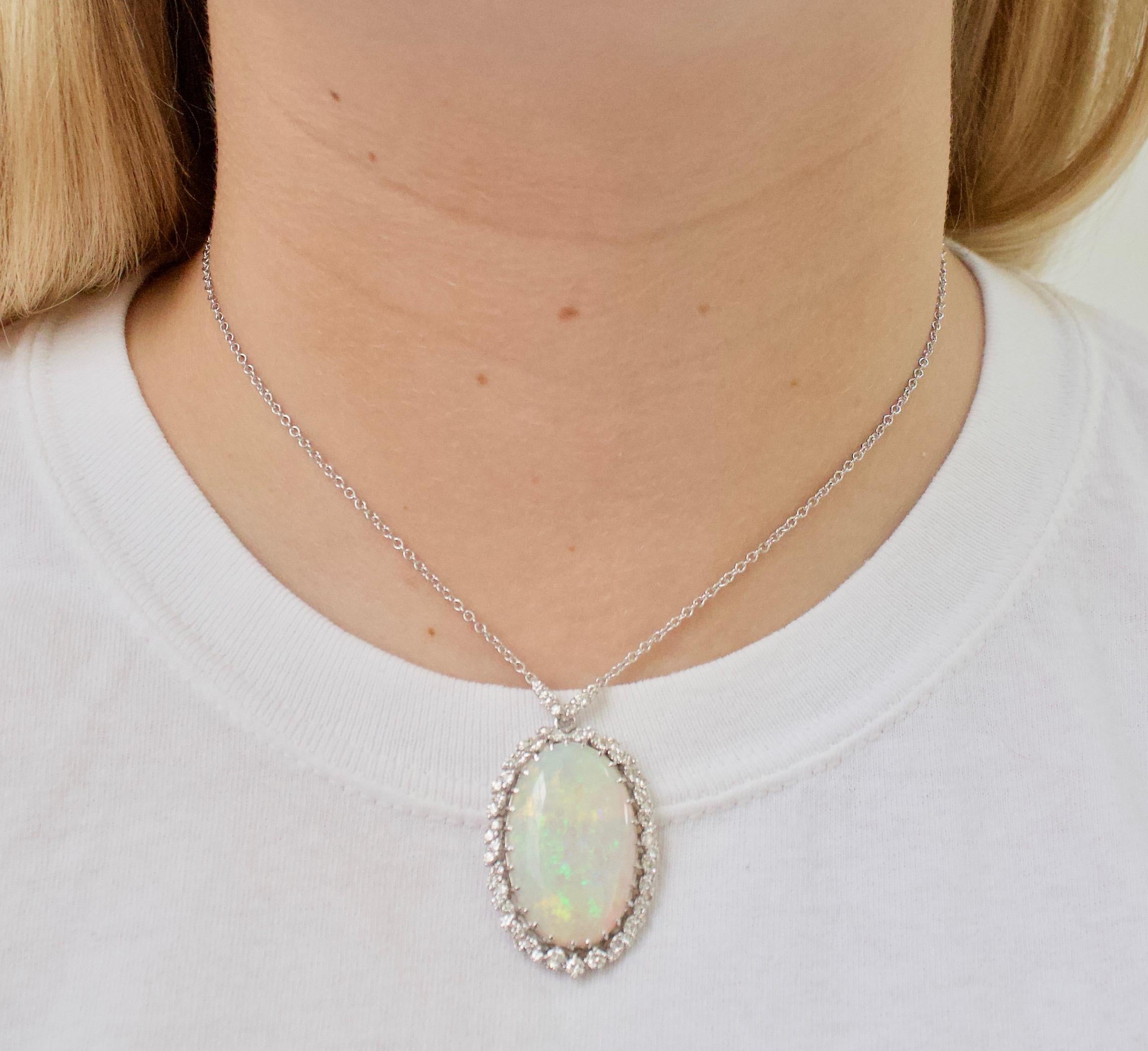 Opal and Diamond Vintage Necklace  in 18k Gold Circa 1960's
Purchased From a Los Angeles Family's Estate
Features a Beautiful 14.00 carat (approximately) Natural Opal. Translucent with Green, Blue and Yellow Plays of Color.  
57 Round Brilliant Cut