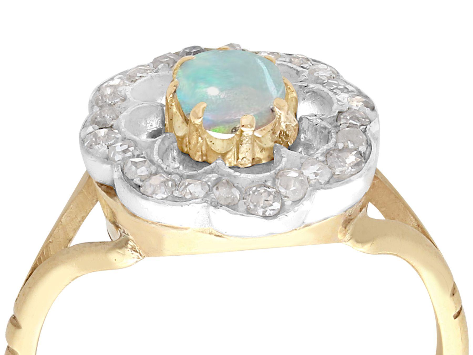 A fine and impressive antique 0.28 carat opal and 0.39 carat diamond, yellow gold and silver set dress ring; part of our diverse antique jewelry and estate jewelry collections.

This fine and impressive antique cabochon cut opal ring has been