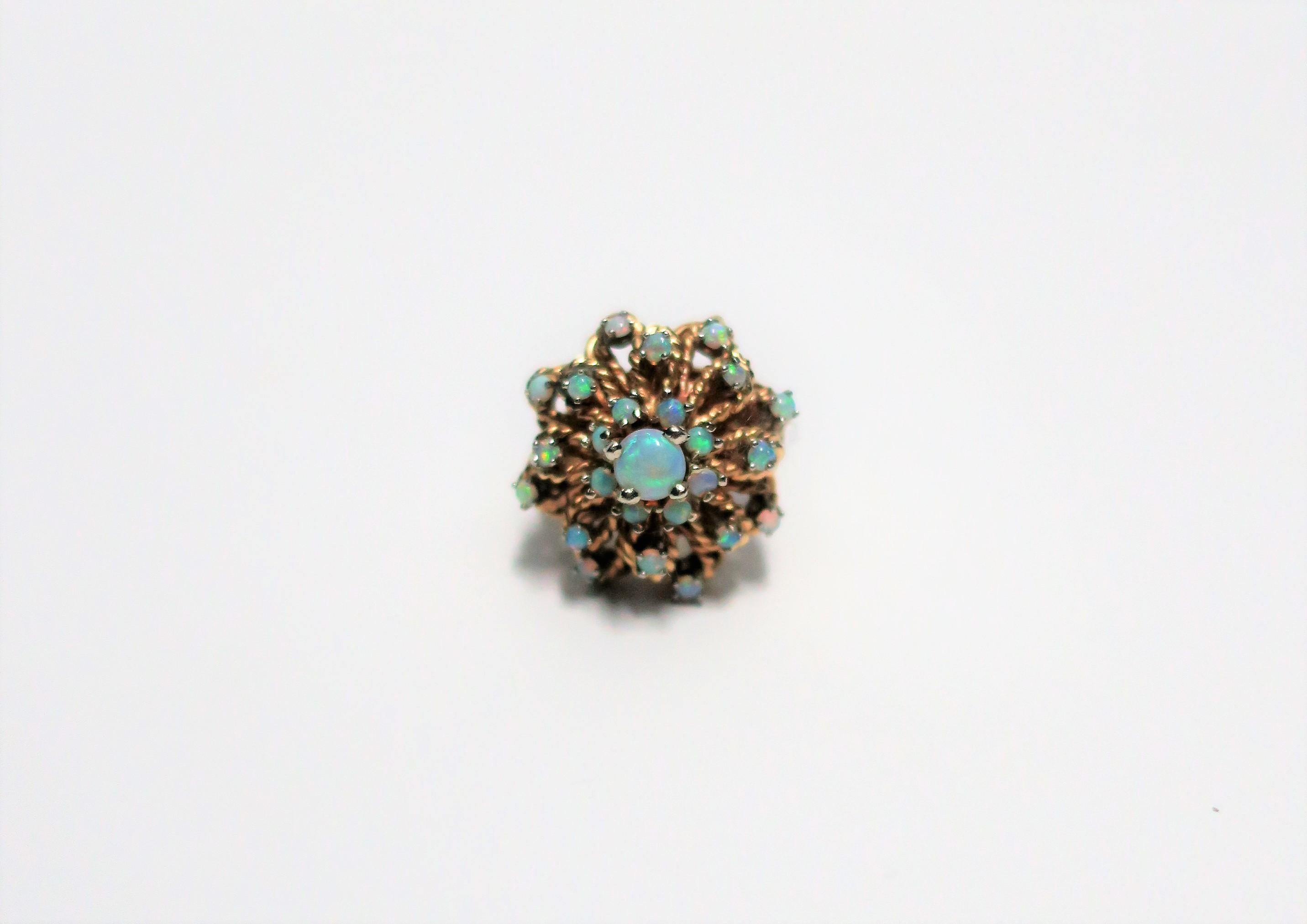 A very beautiful vintage opal gemstone and 14-Karat yellow gold cocktail ring, circa 1960s. Ring is well-made, substantial; comprised of 22 quality round opals, all prong set, with a ribbed shank/band. A rare find. A great piece that can be worn