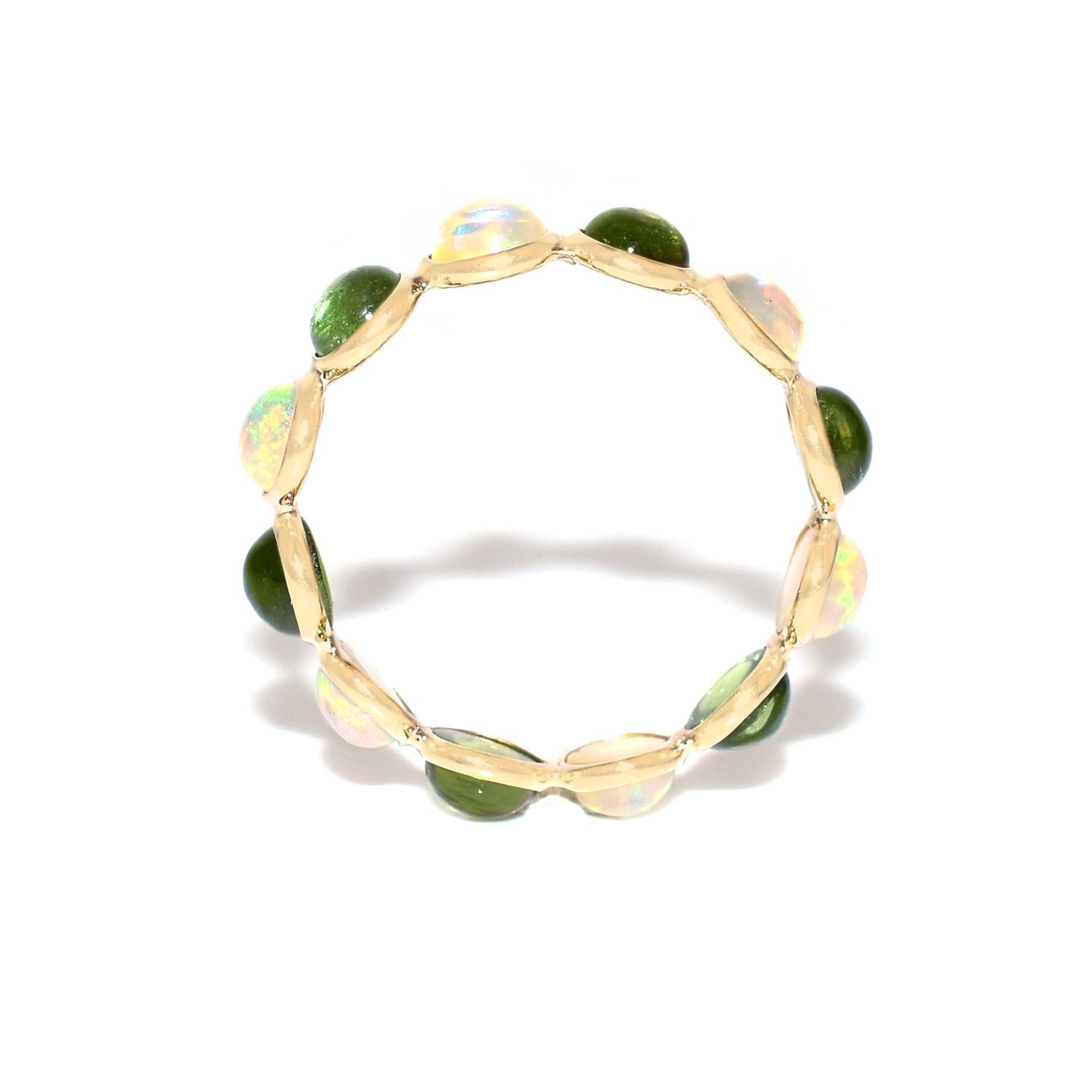 Shape: Round Cabochon

Stones: Opal and Green Tourmaline

Metal: 14 Karat Yellow Gold (can be customized)

Style: Single Line Band

Ring Size: US 7.25 (can be customized)

Stone Weight: appx. 3.75 carats of Opal and Pink Tourmaline 

Total Weight:
