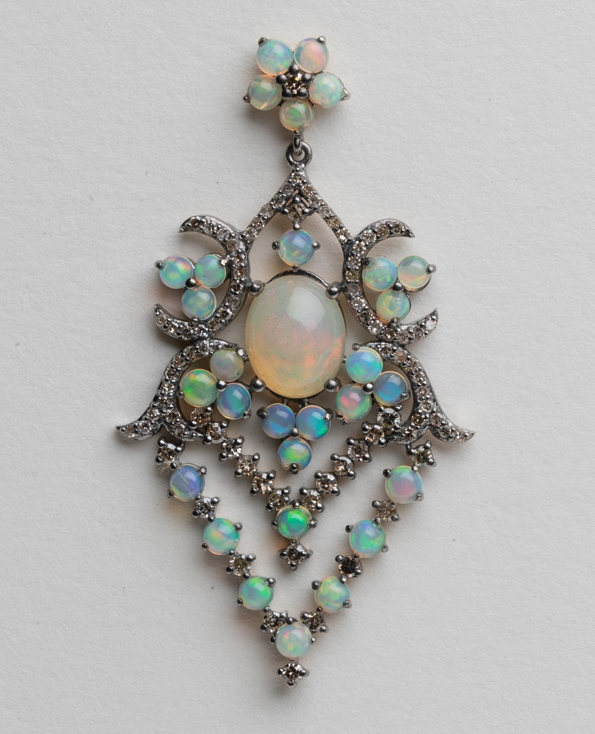 A pair of lovely opal and pave` diamond dangle chandelier earrings.  Diamonds are round cuts and set in an oxidized sterling with 18K gold post for pierced ears.  Post is a subtle flower of opals with diamond center.  Opals with a great fire and