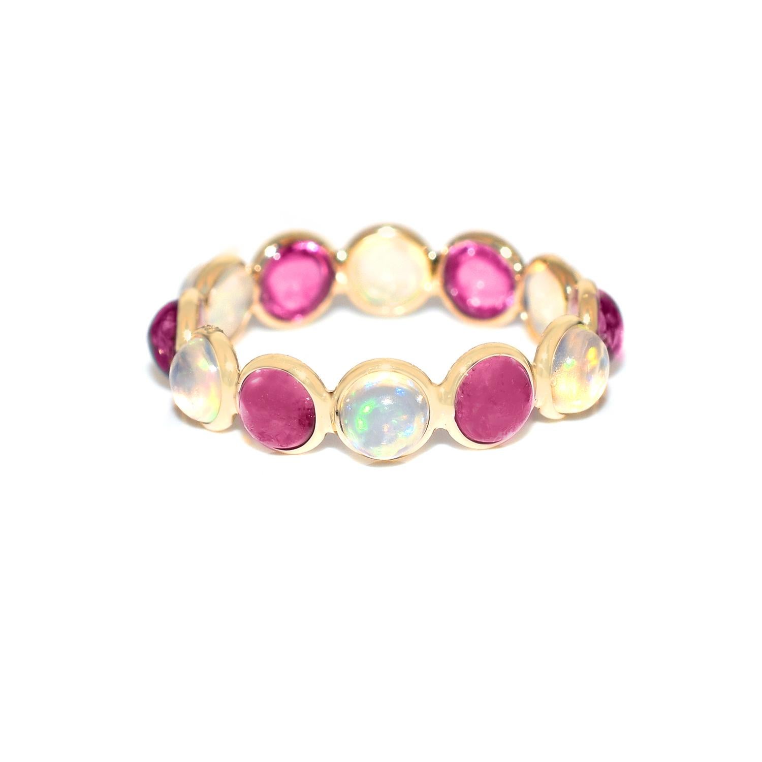 Shape: Round Cabochon

Stones: Opal and Pink Tourmaline 

Metal: 14 Karat Yellow Gold (can be customized)

Style: Single Line Band

Ring Size: US 6.25 (can be customized)

Stone Weight: appx. 3.50 carats of Opal and Pink Tourmaline 

Total Weight: