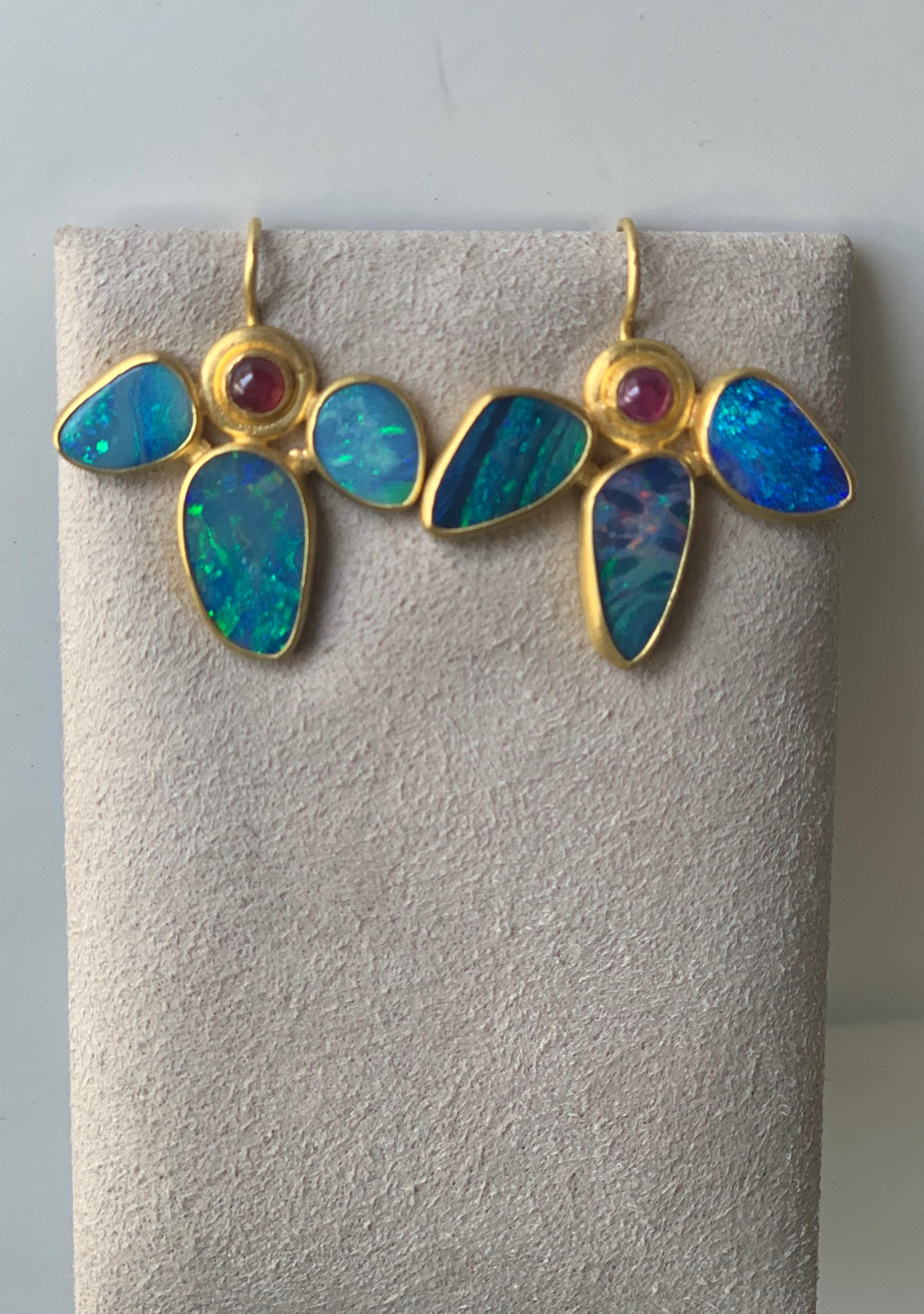 Lotus earrings of opal and ruby. Inspired  by a recent visit to the Bronx Botanical Gardens and by ancient Egyptian jewelry, these earrings are truly stunning and unique.
Comprised of 24cts of opals and 1.10 cts ruby cabochons they are entirely hand